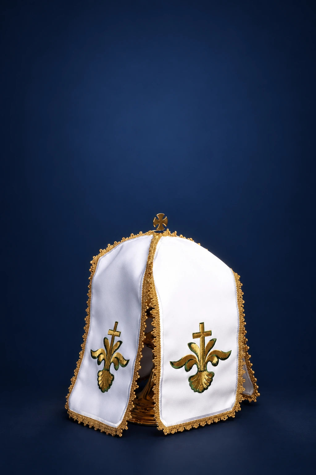 Front view of a white ciborium veil with gold trim and embroidered crosses on the panels