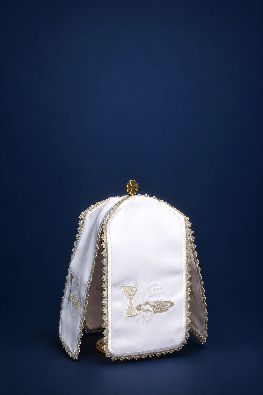 Front view of a white ciborium veil with silver chalice and host embroidery and gold trim