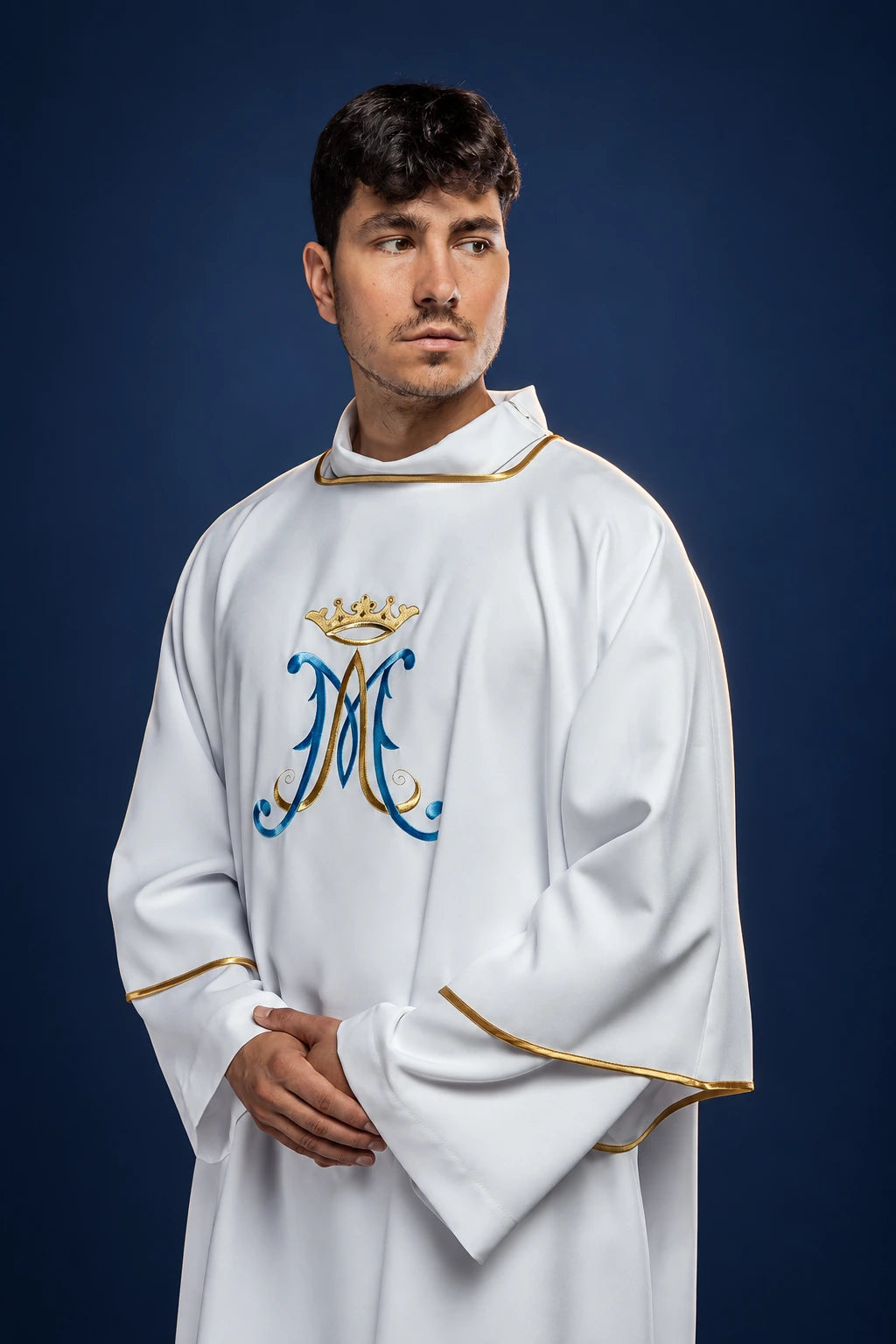 Front view of a white dalmatic with gold trim and Marian monogram embroidery on the chest