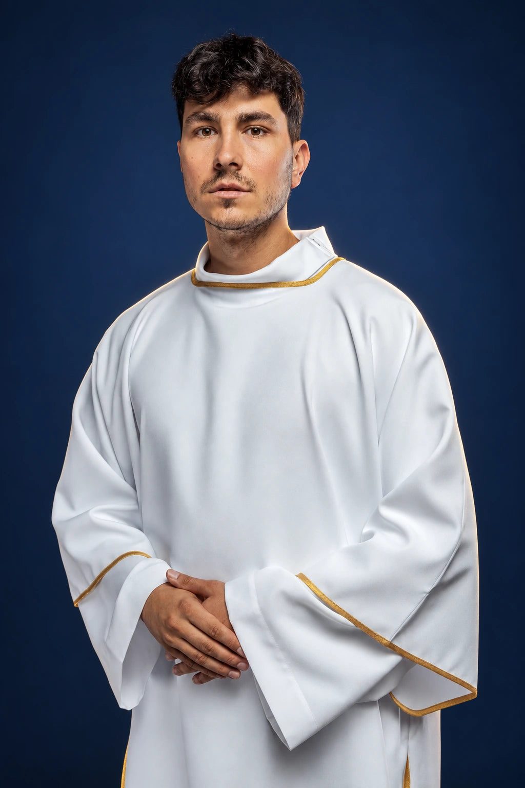 Front view of a white dalmatic with gold trim and wide sleeves