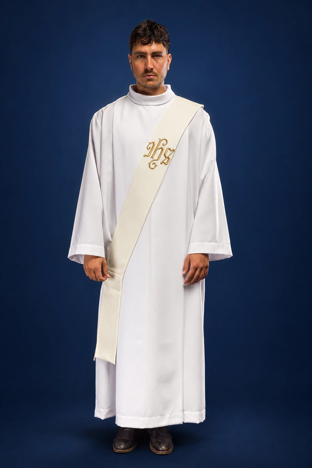 Front view of a white deacon stole with gold IHS embroidery worn over a white alb