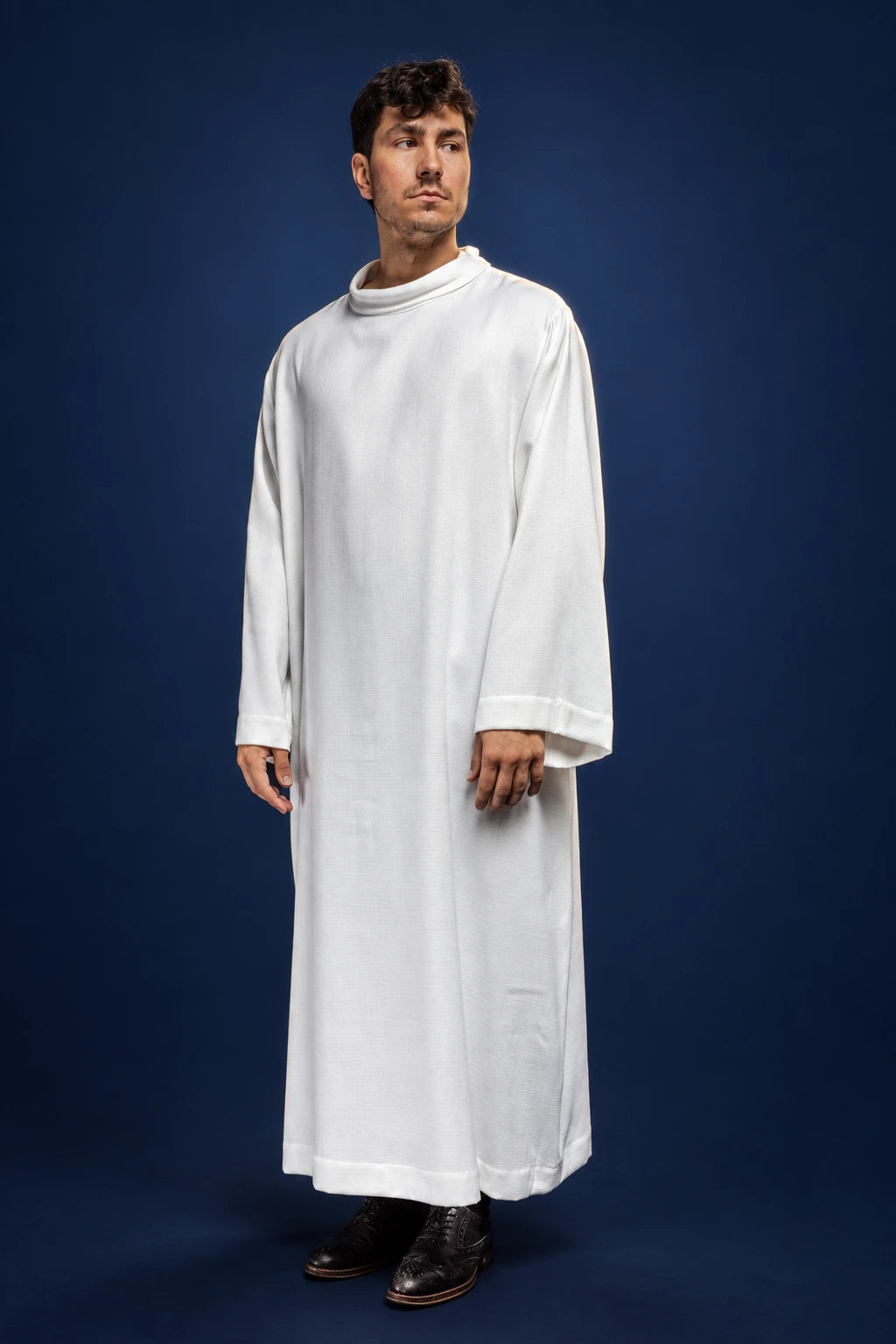 Front view of a white linen priest alb with wide sleeves and natural-weave neckline trim