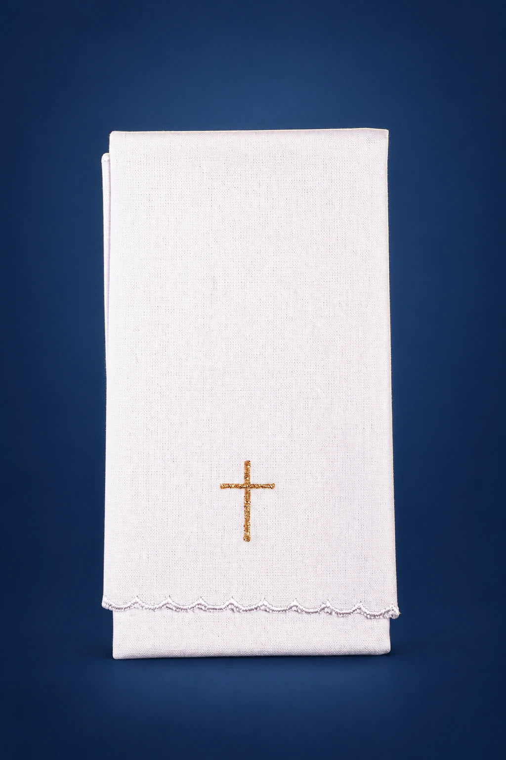 Front view of a white purificator with a small gold cross and scalloped embroidered hem