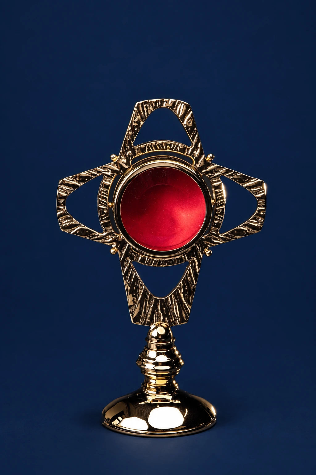 Gilded brass reliquary with red center, front view on ornate stand