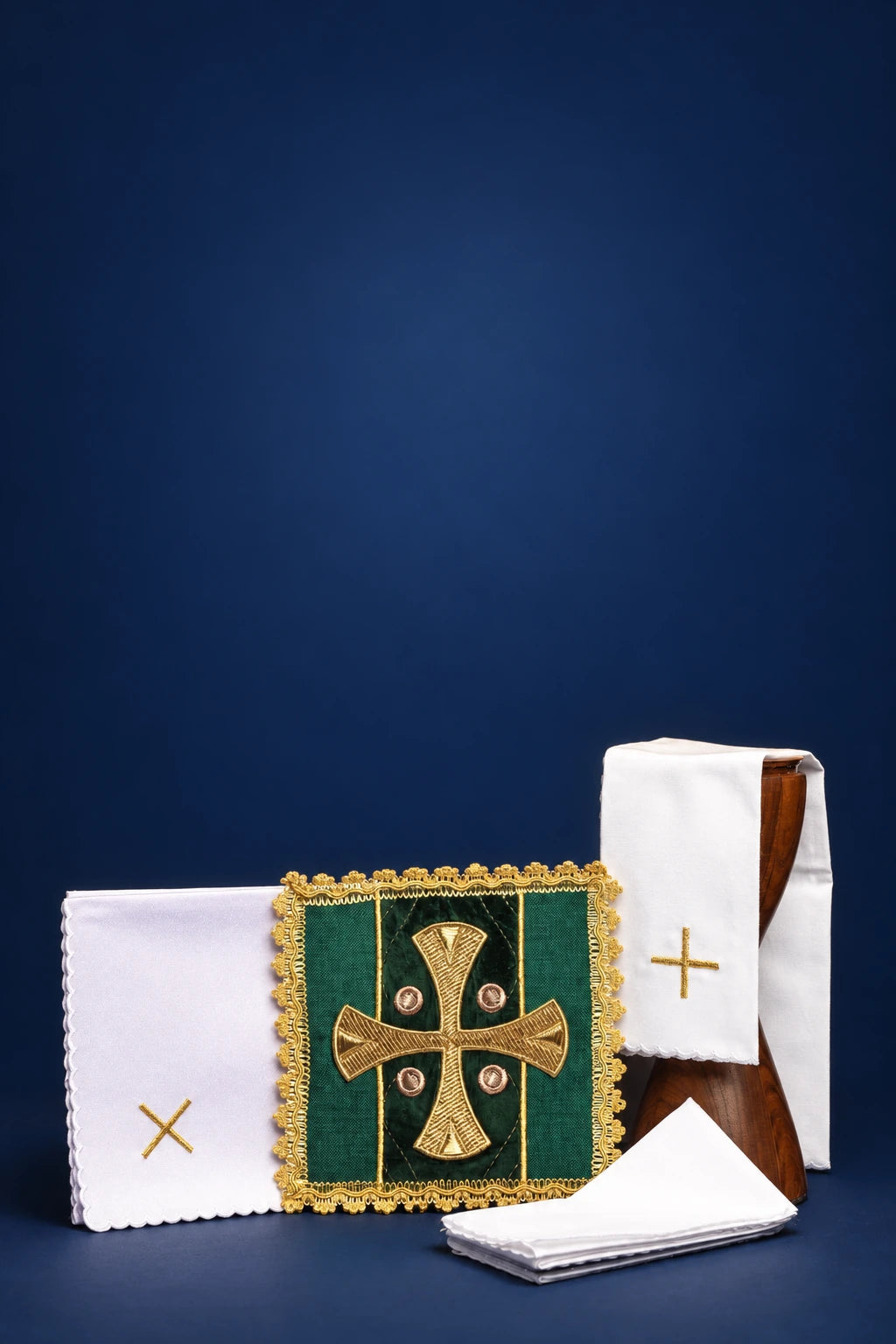 Green altar linen set with embroidered cross pall and folded white linens