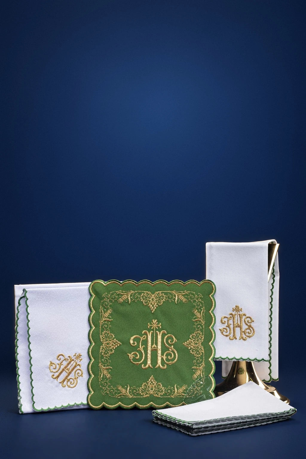 Green altar linen set with embroidered IHS monograms and scalloped edging, shown folded