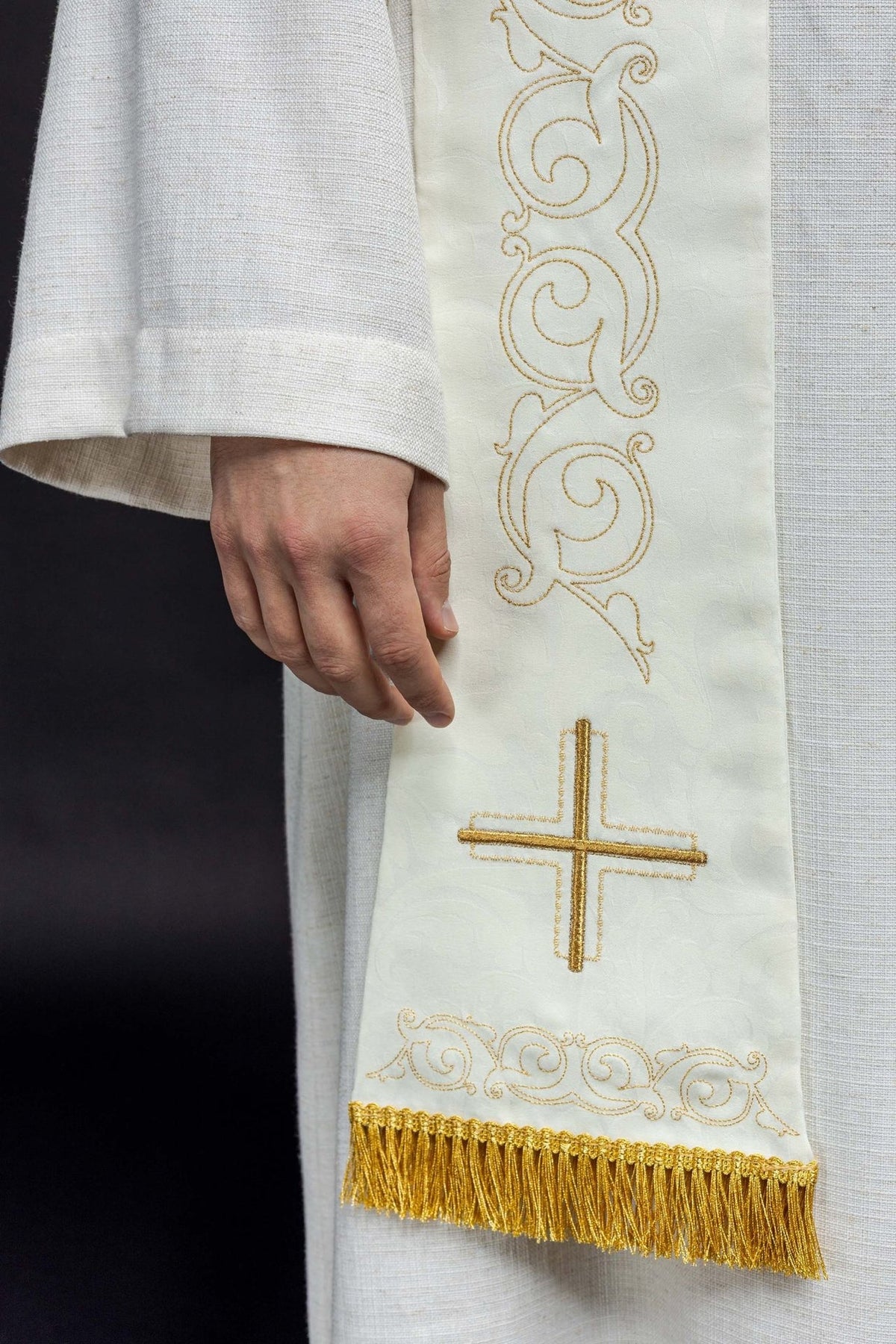 Roman stole close-up with gold cross embroidery, scrolls and fringe