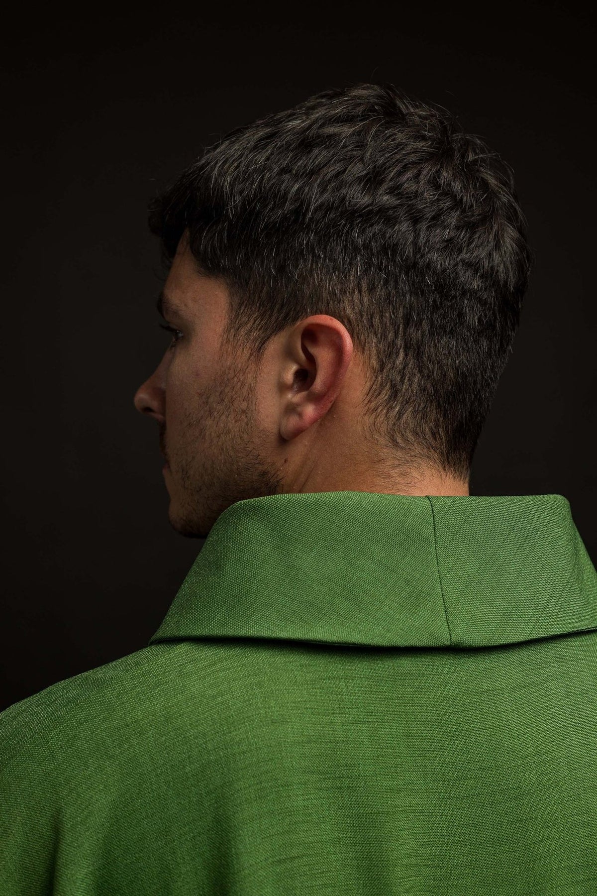 Green chasuble side-back close-up showing the collar and gold cross detail