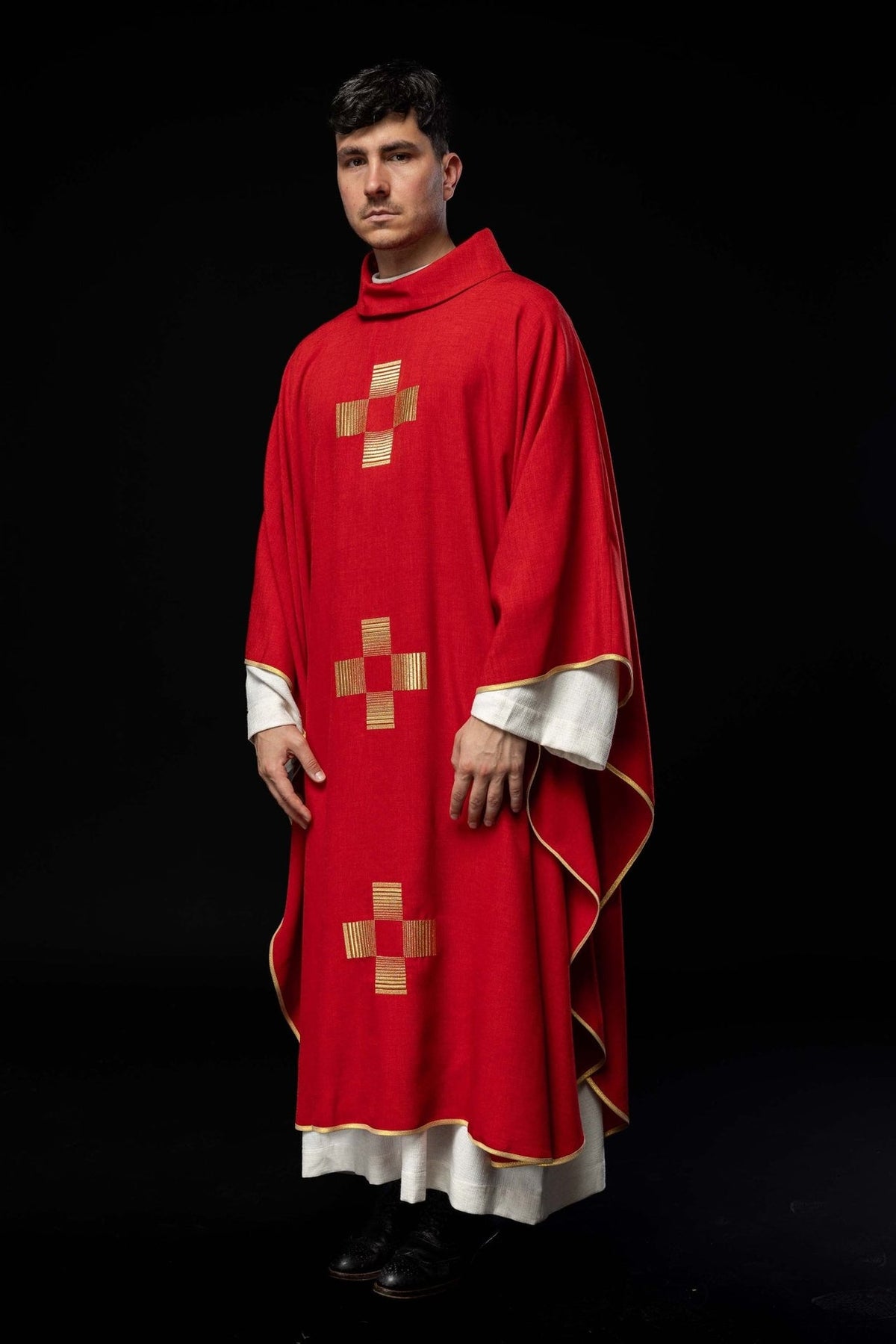 Red chasuble worn in a front three-quarter view with three gold embroidered crosses
