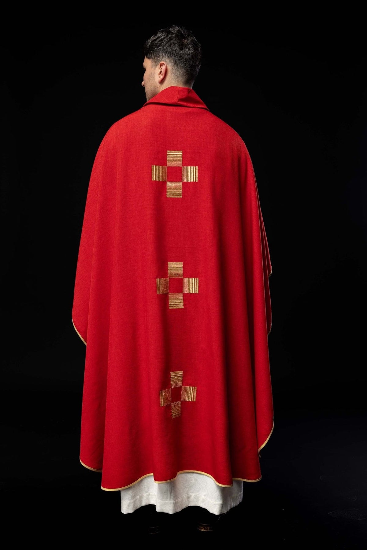 Red chasuble back view with three gold embroidered crosses and gold trim