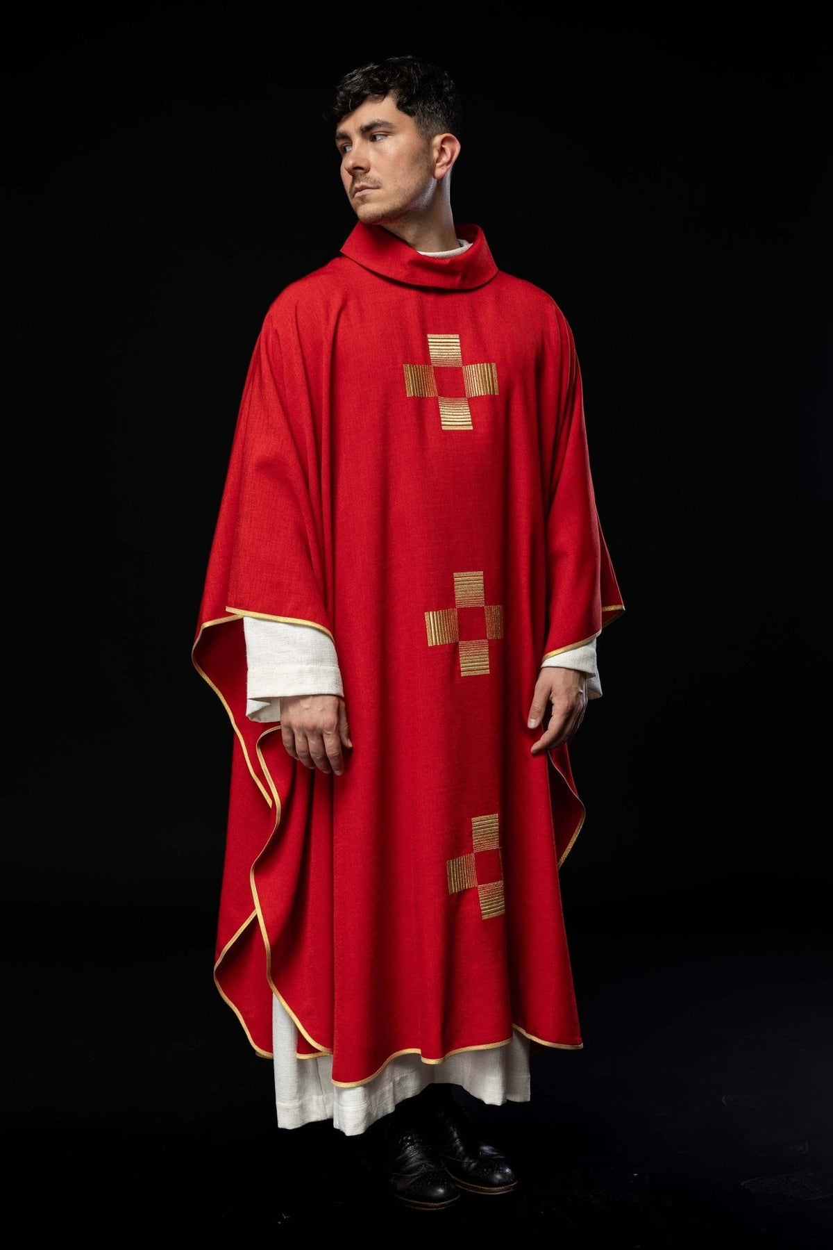 Red chasuble worn from the front with gold embroidered crosses and gold trim