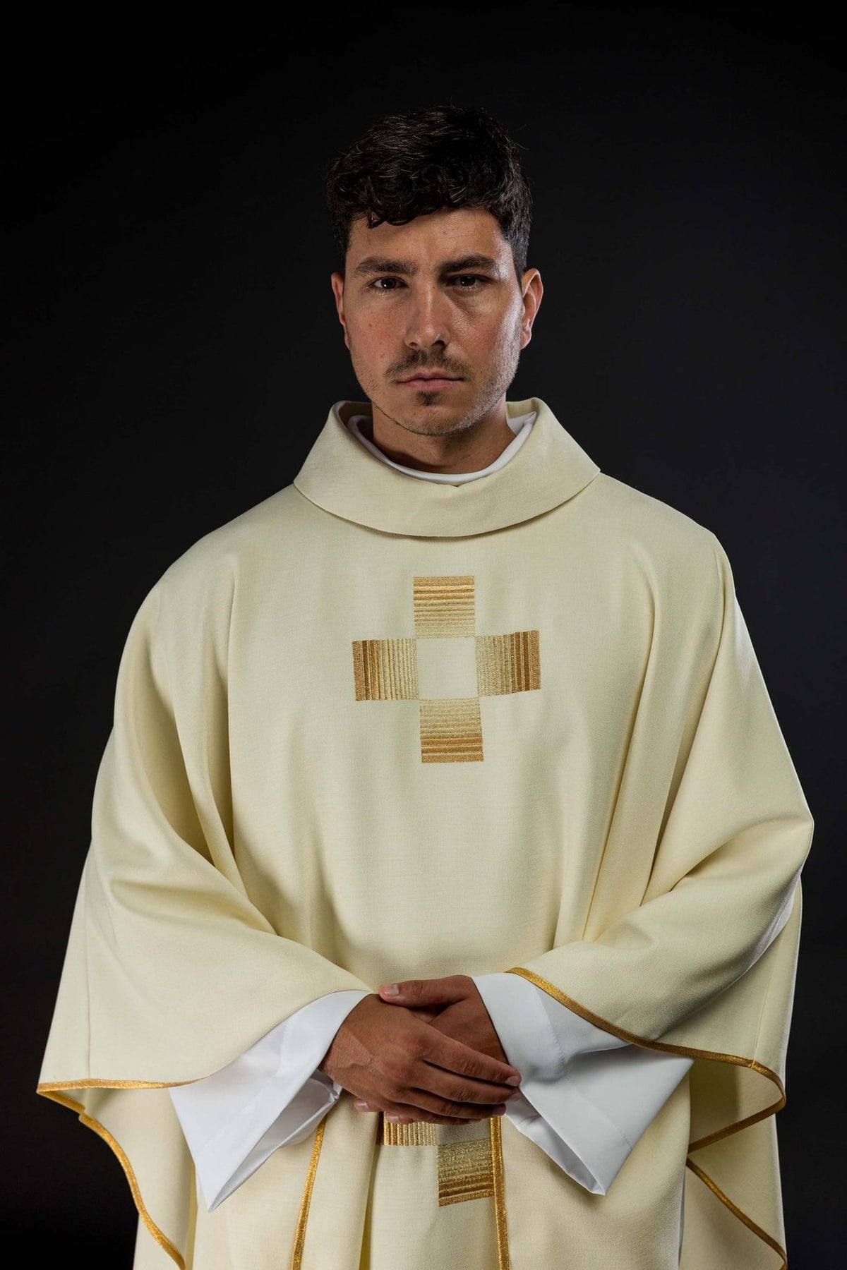 Ivory chasuble close-up showing the front embroidered gold cross