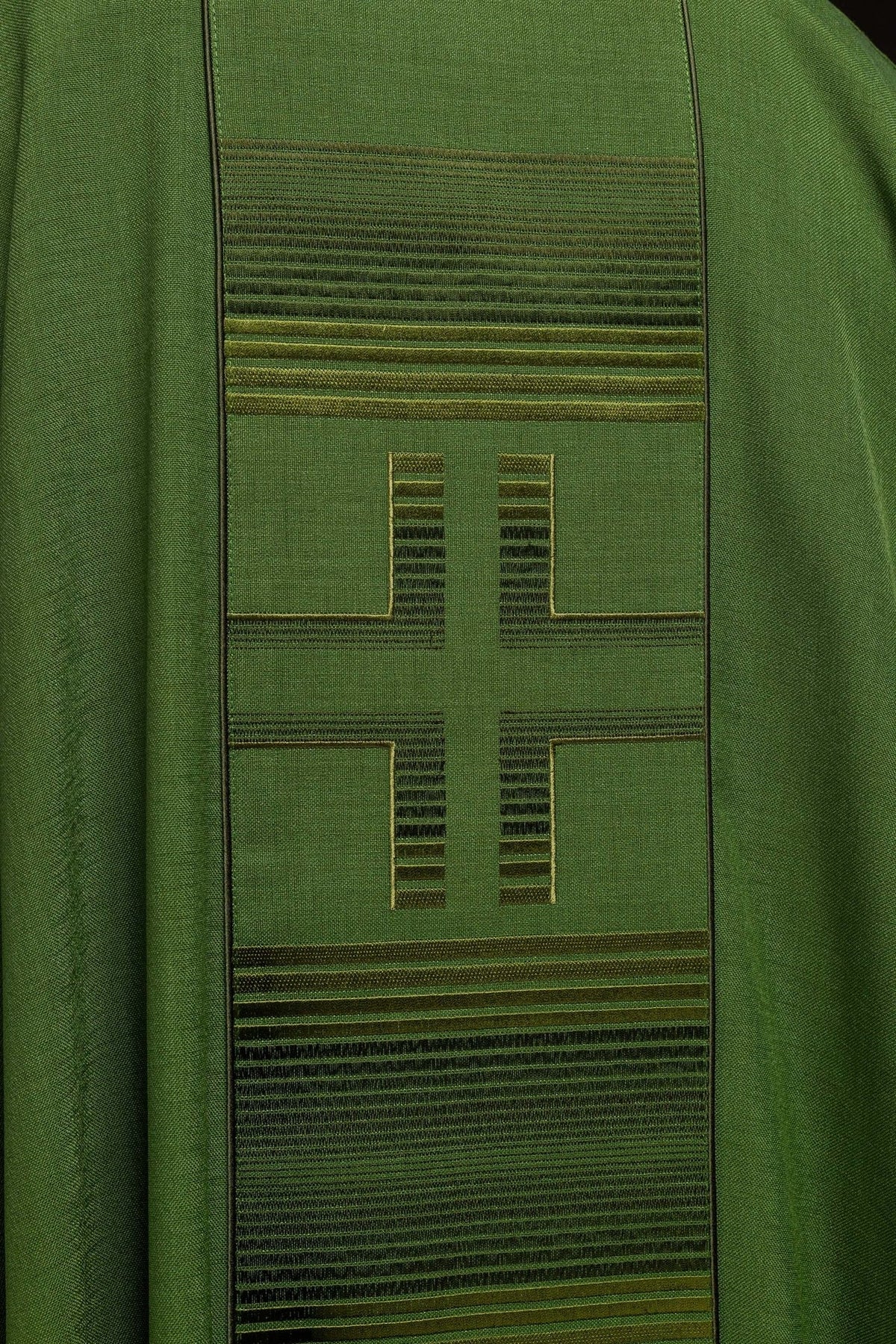 Green chasuble embroidery close-up with cross and horizontal trim