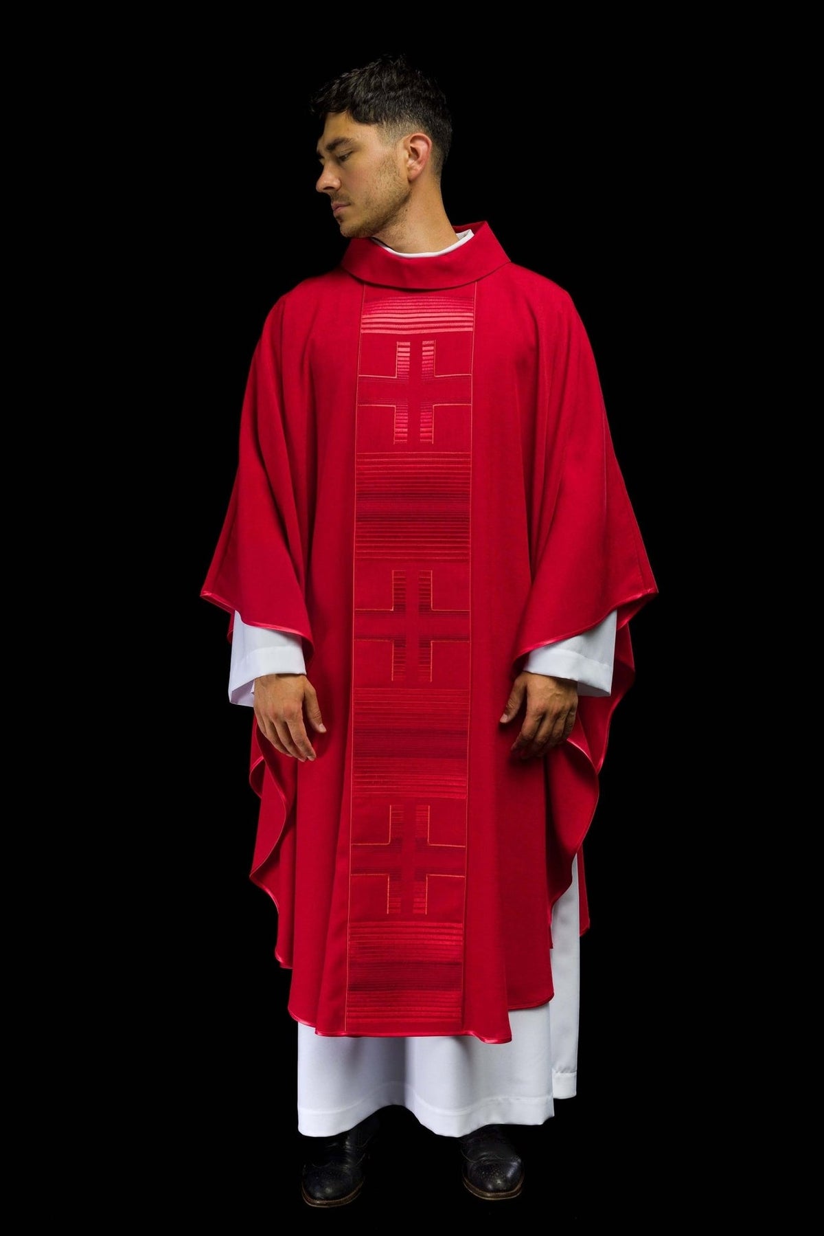 Red chasuble worn front, showing embroidered cross trim and wide sleeves