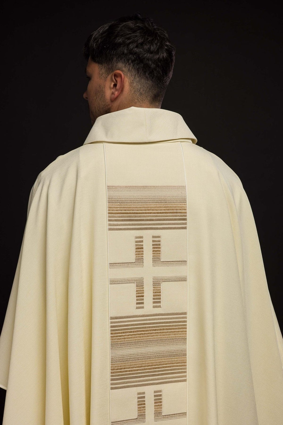 Ecru chasuble back view with repeated crosses and horizontal striped embroidery
