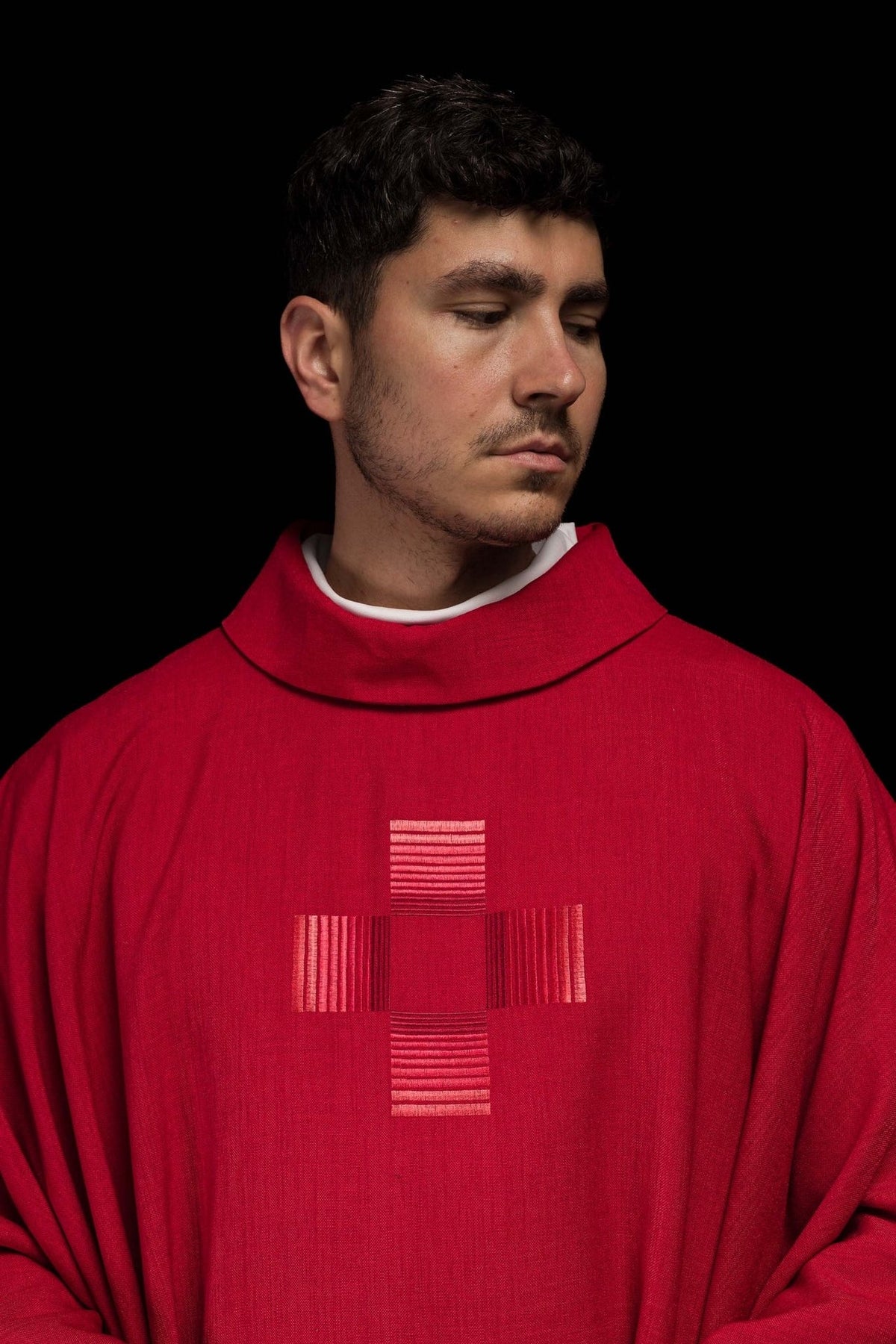 Red chasuble side detail showing red satin trim and fabric