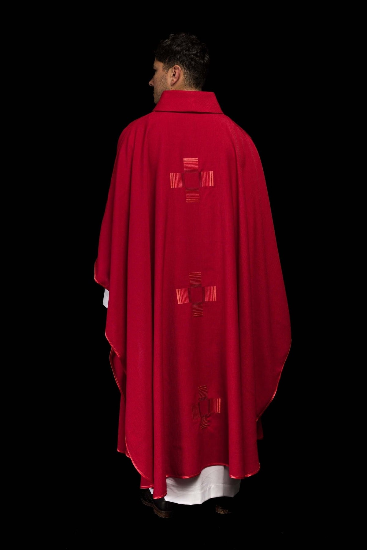 Red chasuble back view with embroidered crosses