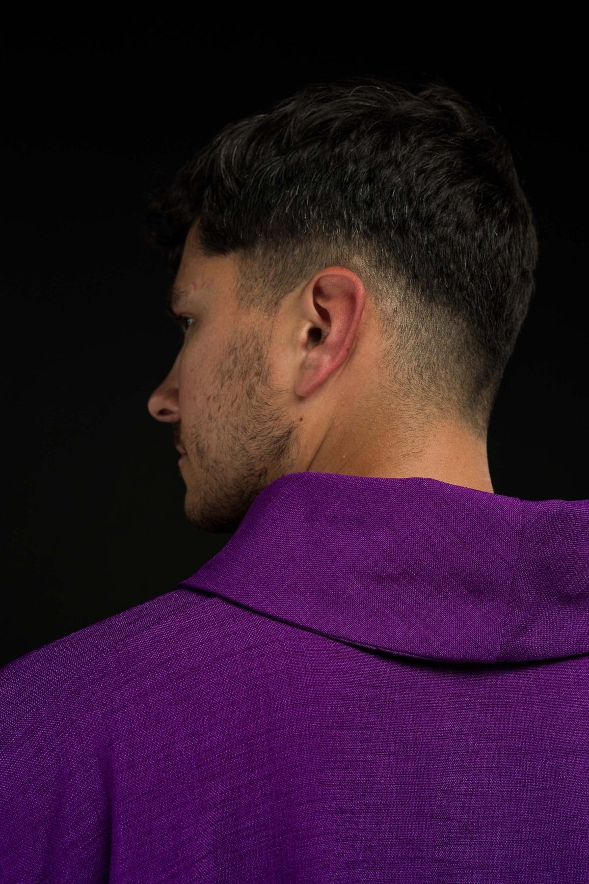 Purple chasuble collar close-up with white trim and cross embroidery