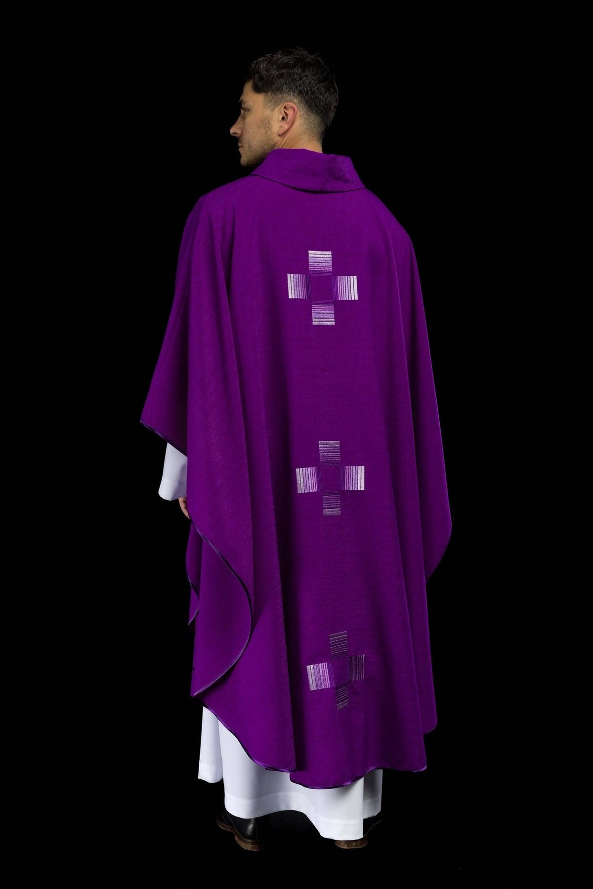 Purple chasuble back view with silver embroidered cross motifs