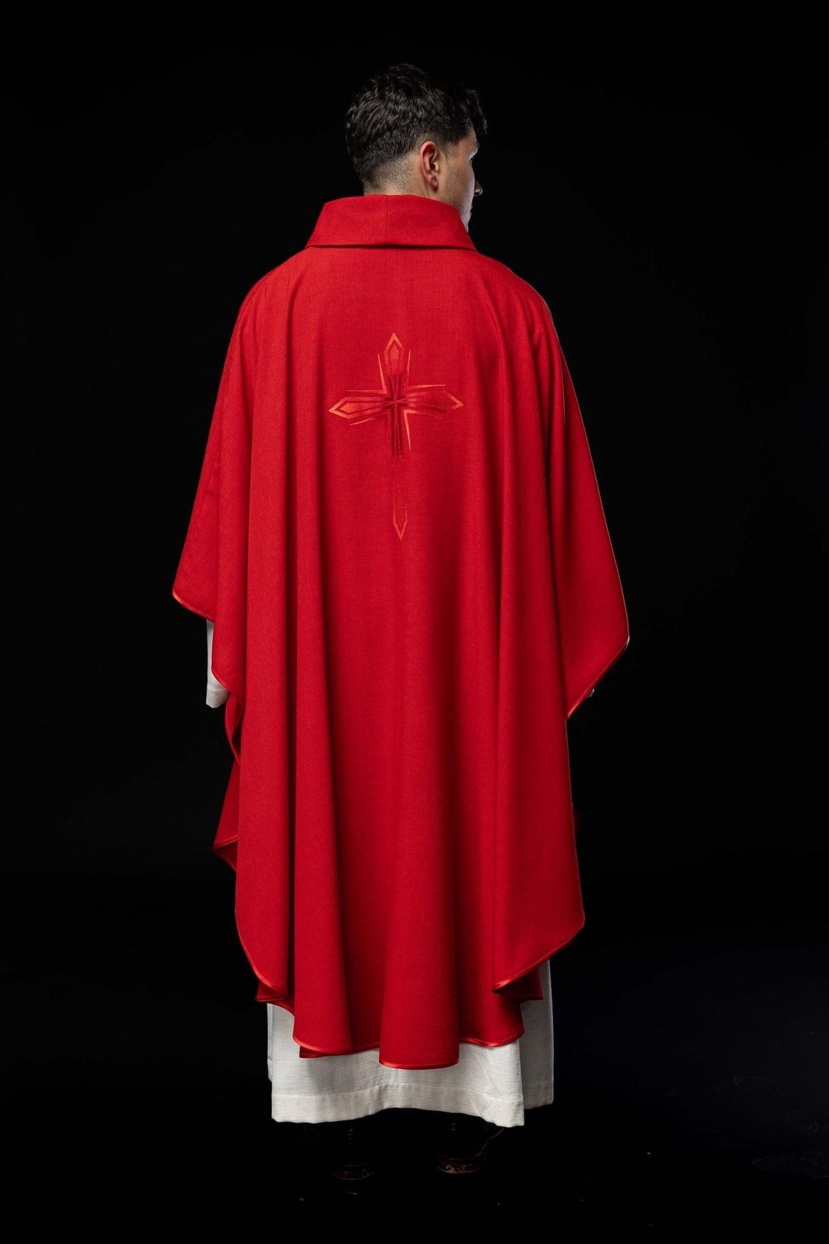 Red chasuble worn from the back with embroidered cross