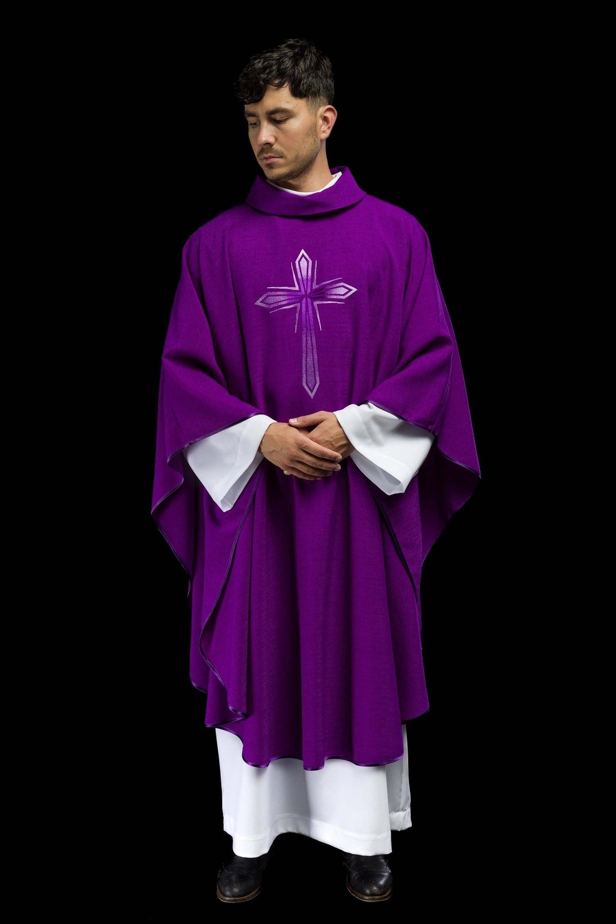 Purple embroidered chasuble worn in a full front view with a silver cross