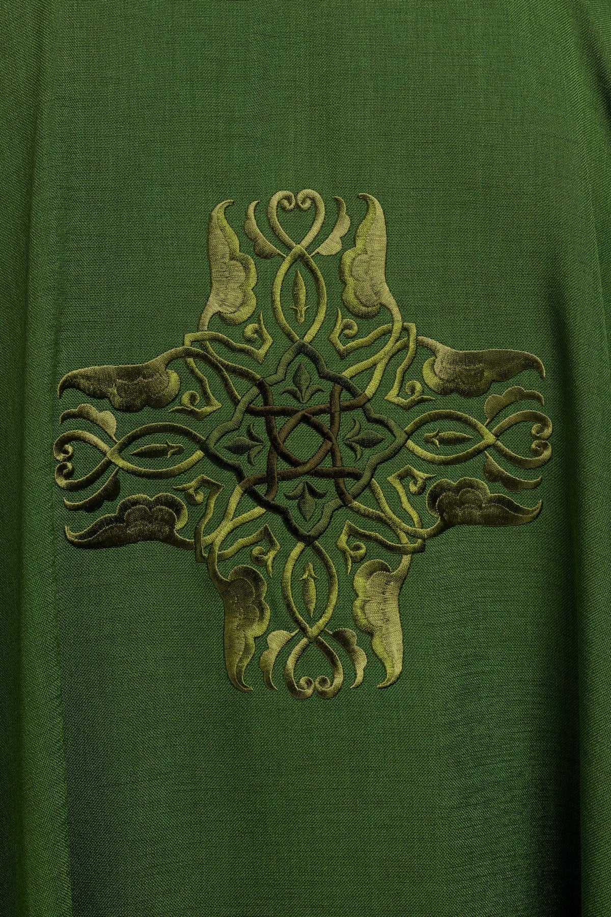 Green chasuble close-up showing full cross embroidery