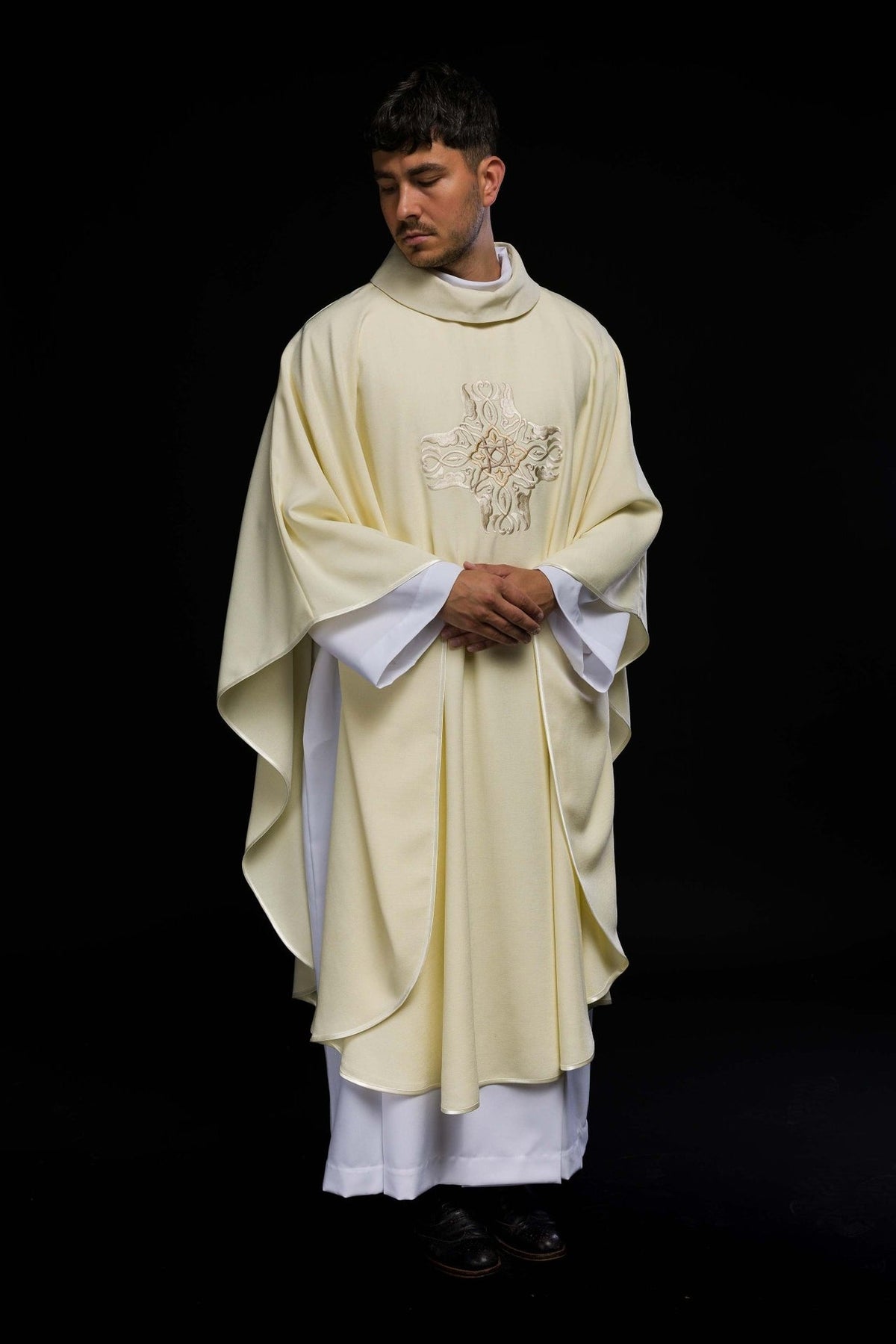 Ecru chasuble front view with embroidered cross and flowing trim