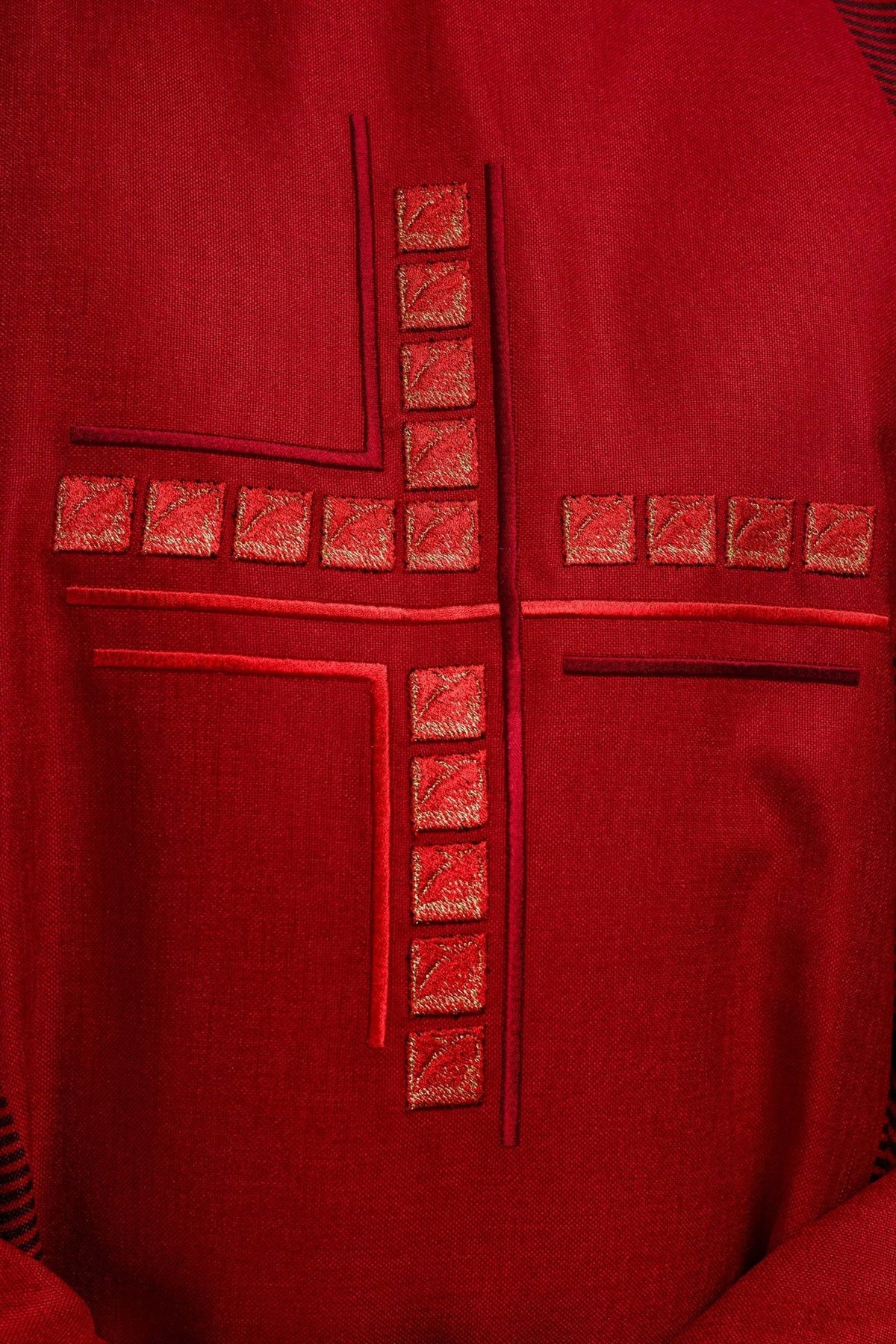 Red chasuble close-up of embroidered cross with square details