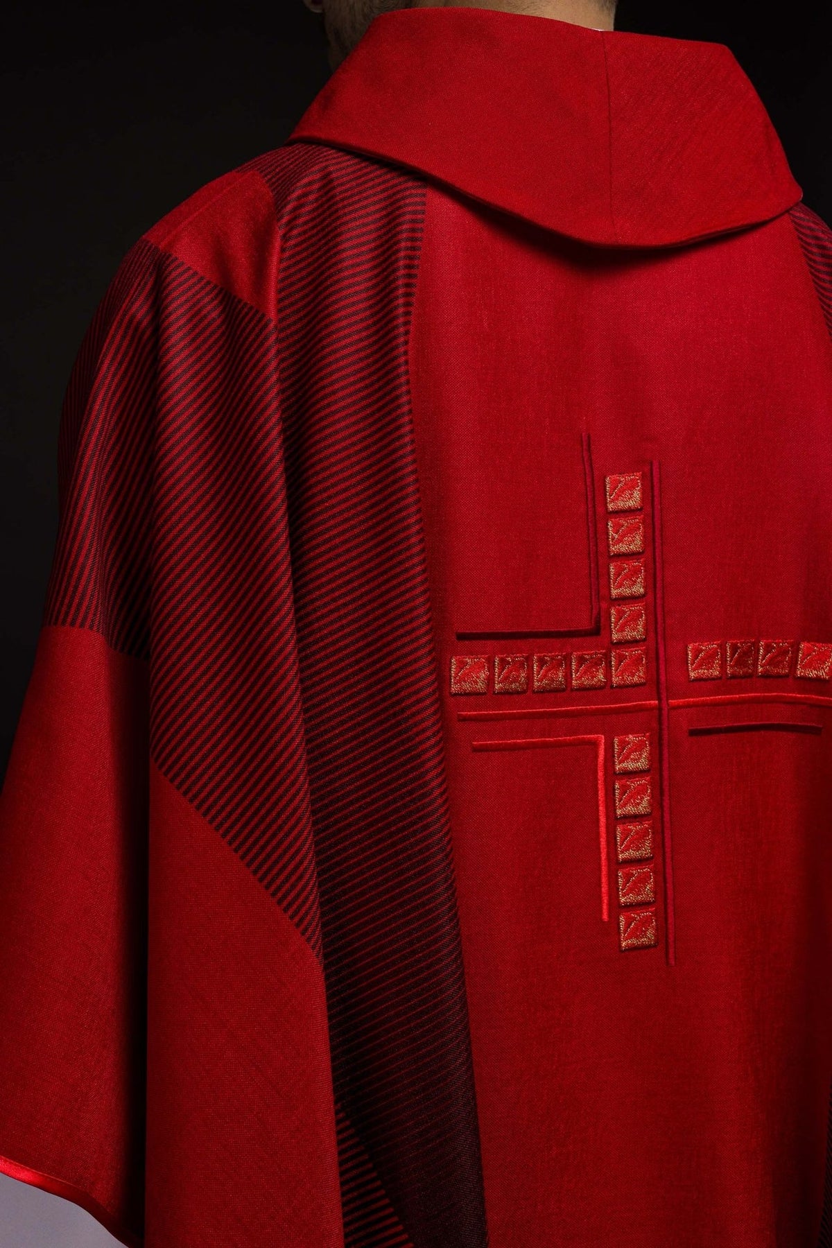 Red chasuble back view with embroidered cross and striped trim