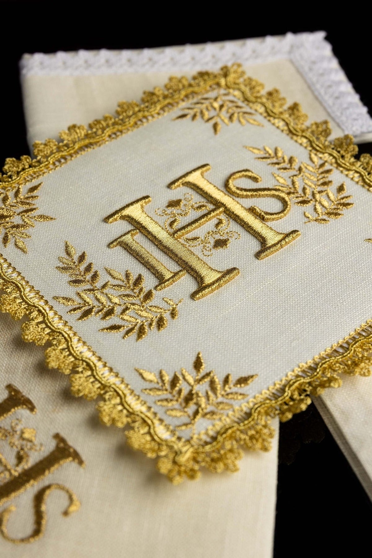 Altar linen set close-up of raised gold IHS embroidery, leafy motifs and ornate border