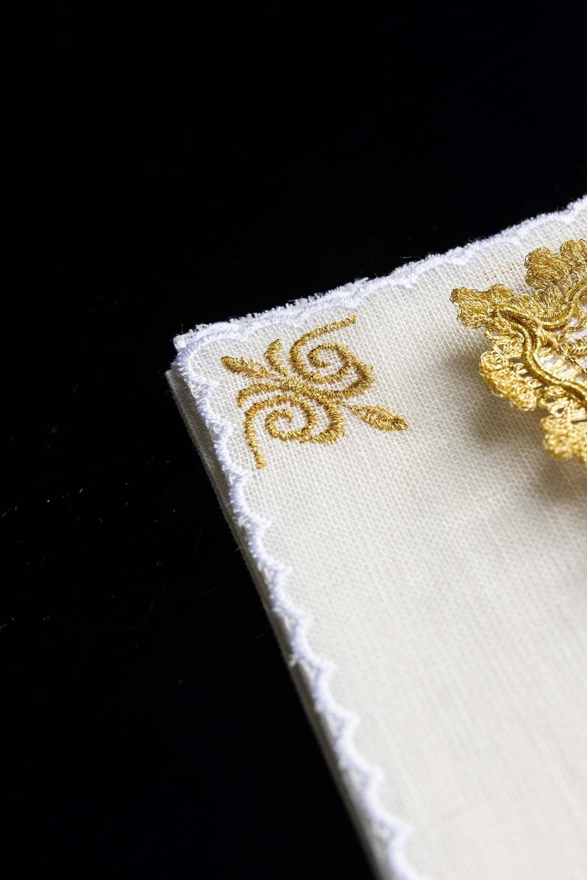 Altar linen set corner detail with gold scroll embroidery and scalloped linen edge