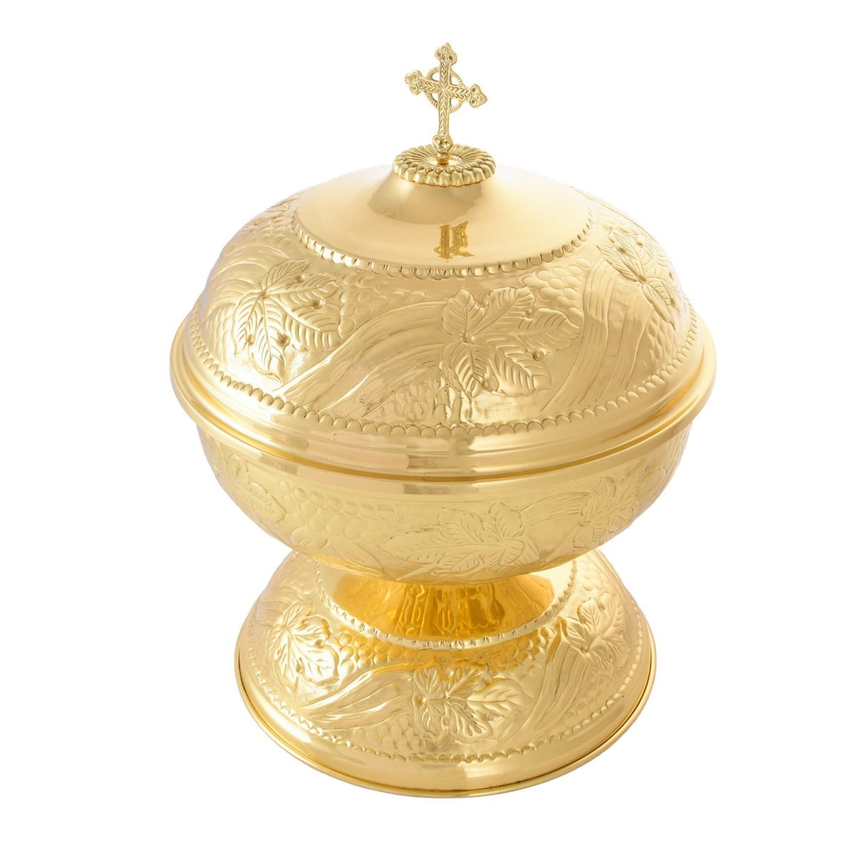 Brass baptismal font close-up showing embossed vine motifs, lid and cross finial