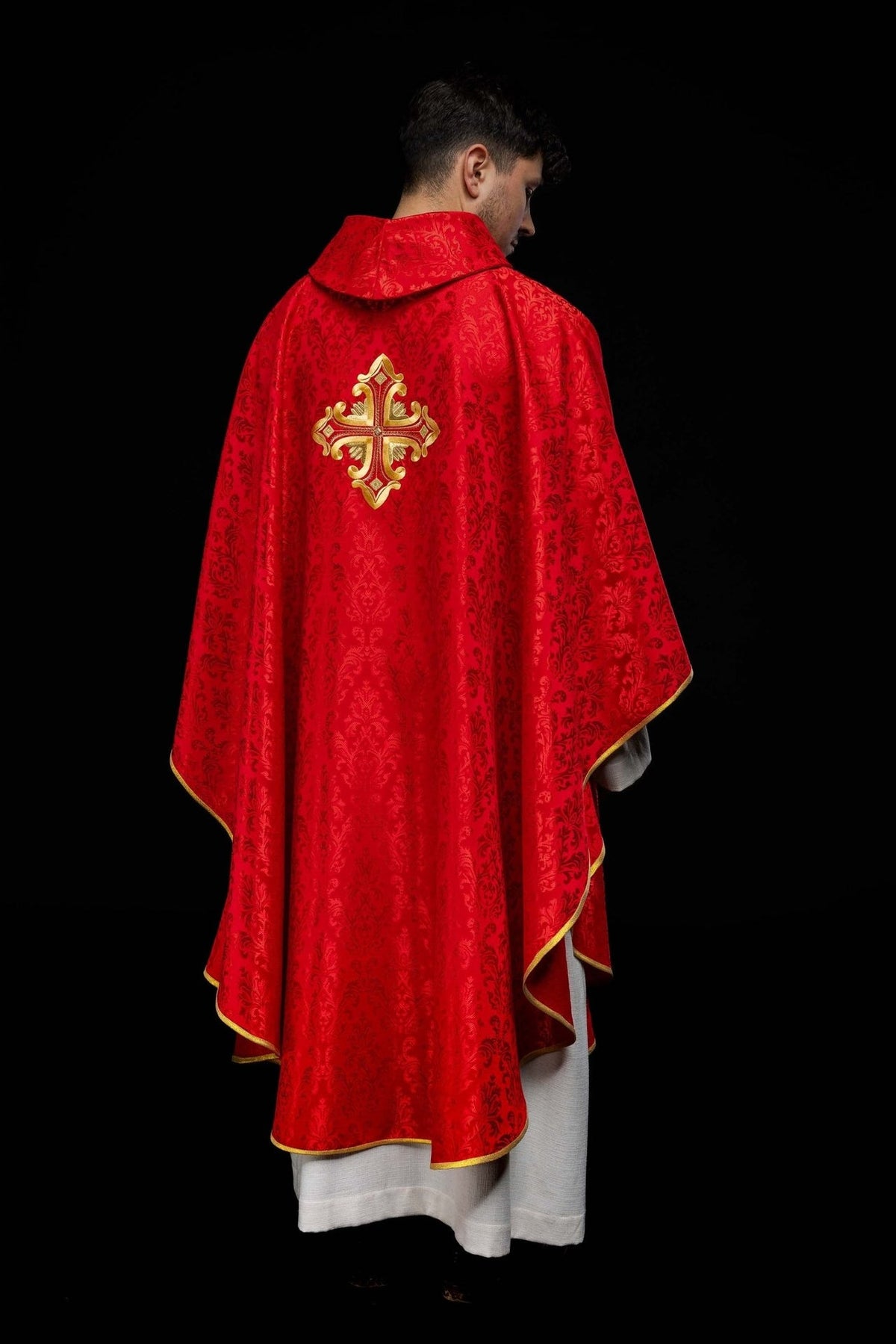 Red chasuble back view with gold embroidered cross and gold trim