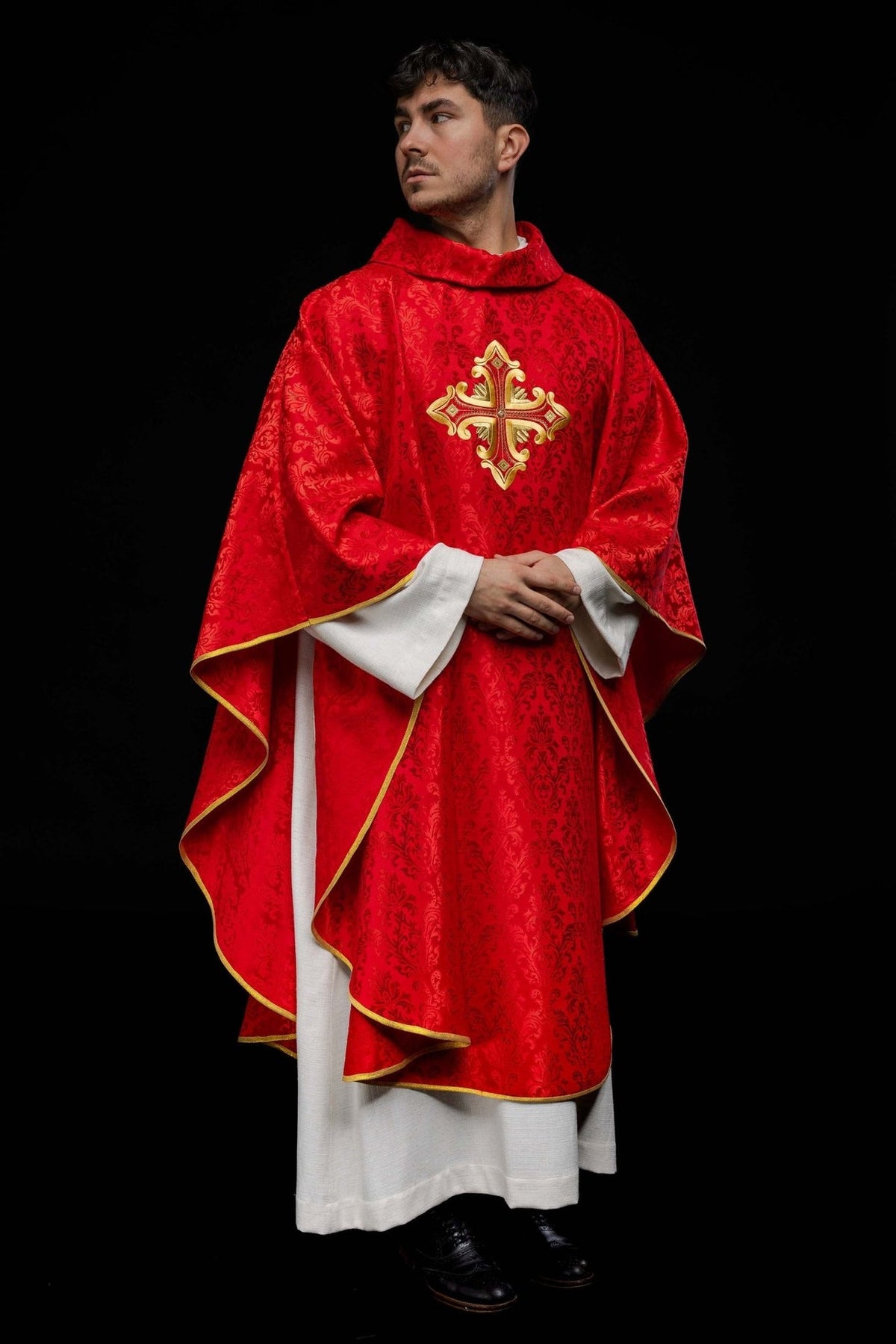 Red chasuble front view with patterned fabric, stand-up collar, gold cross embroidery and trim
