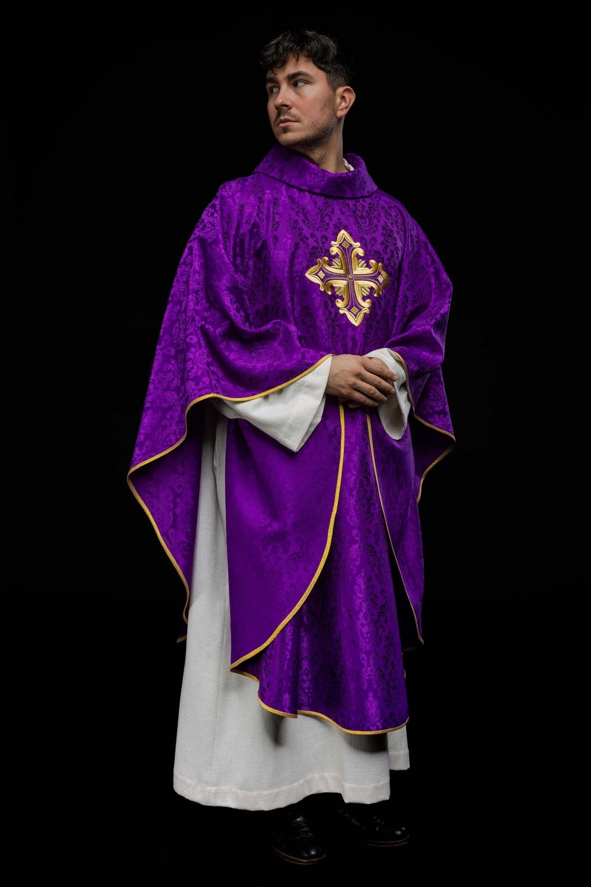 Purple chasuble worn from the side, showing draped trim