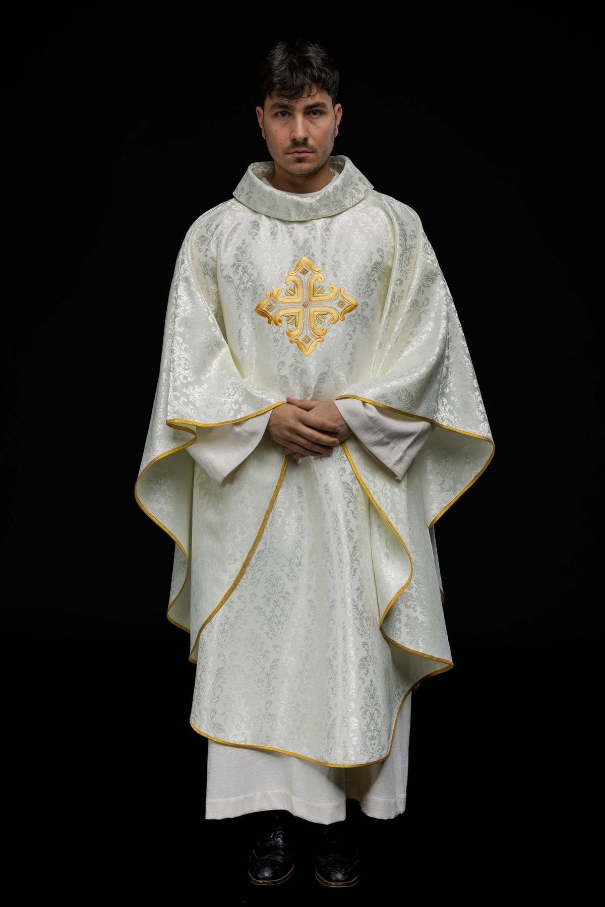 Ecru chasuble front view with patterned fabric, gold cross embroidery and gold trim