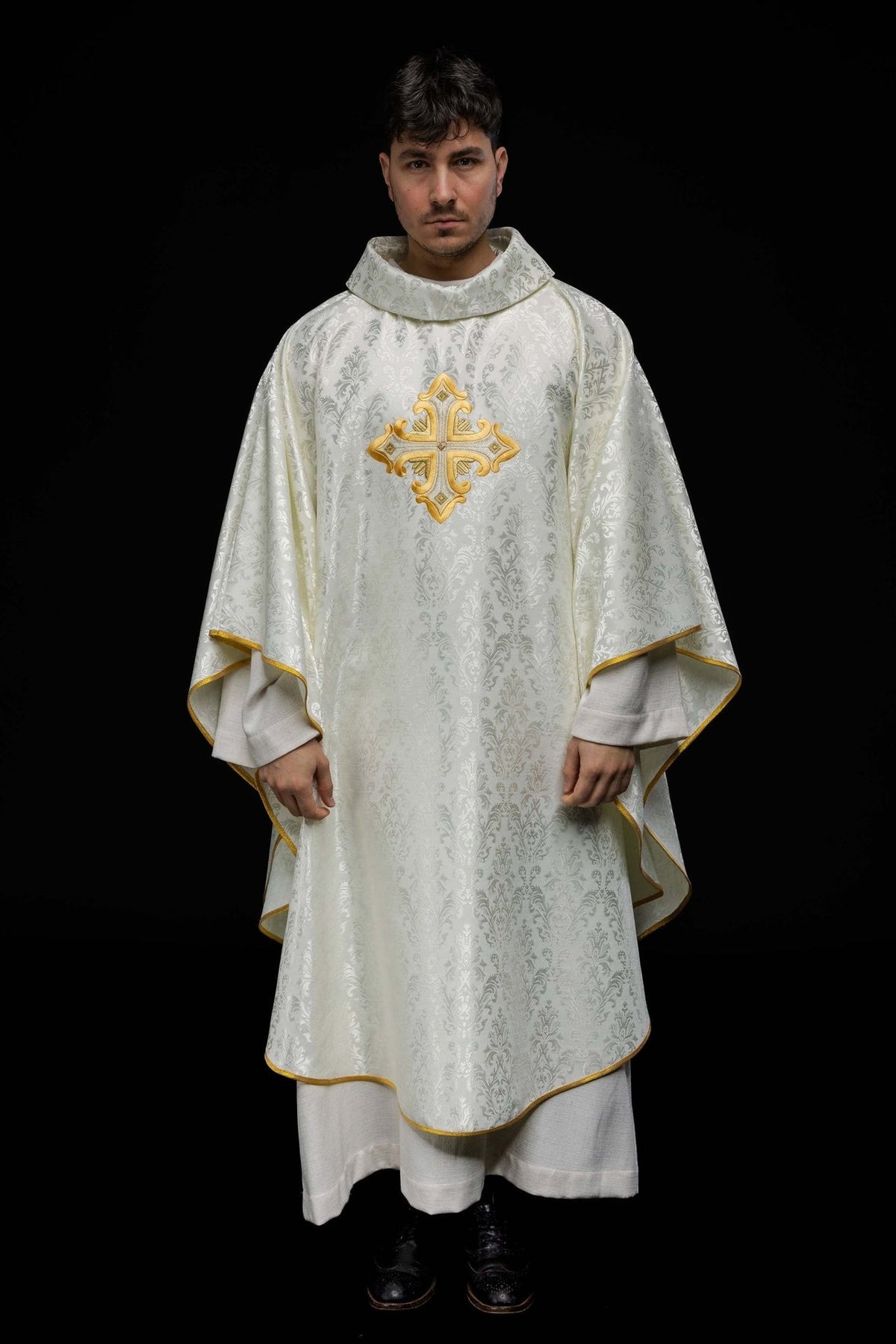 Ecru chasuble front view with gold cross embroidery, patterned fabric and gold trim