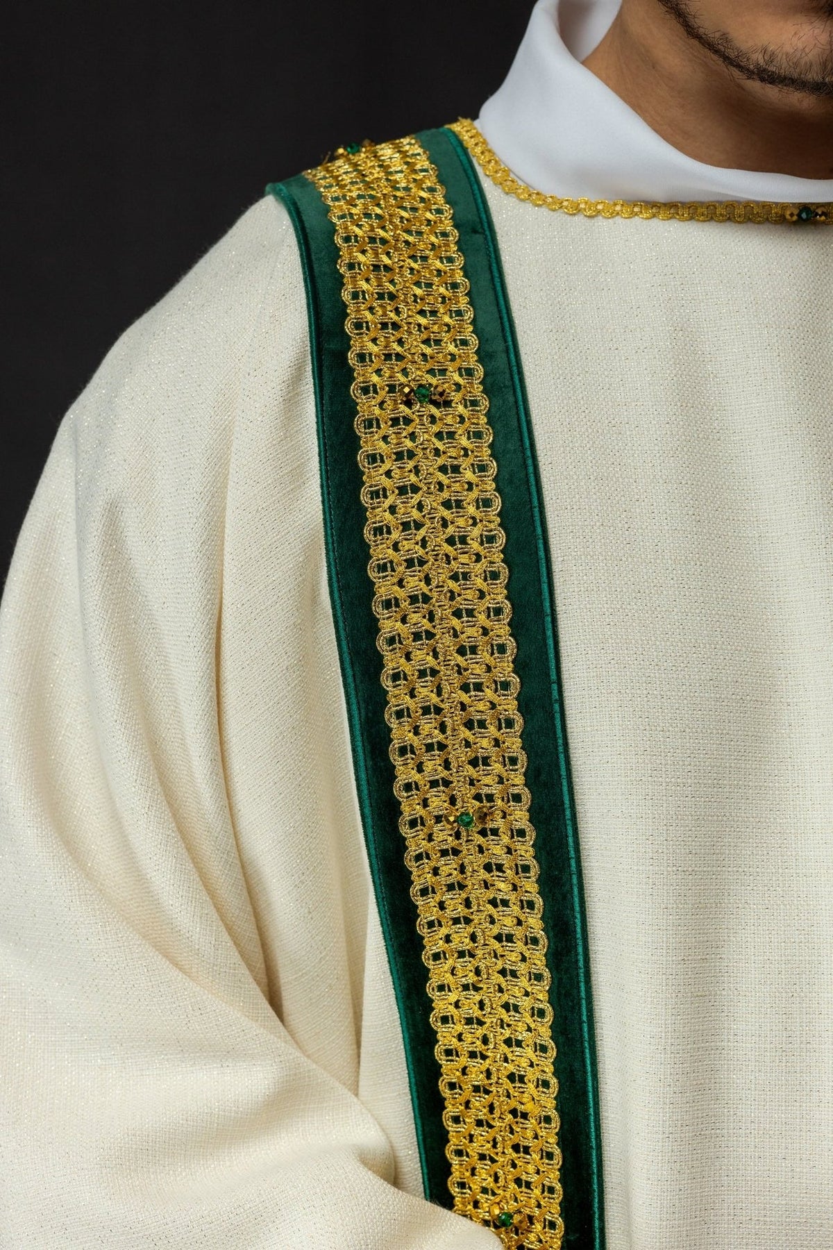 Handcrafted dalmatic close-up of green and gold orphrey with natural stones