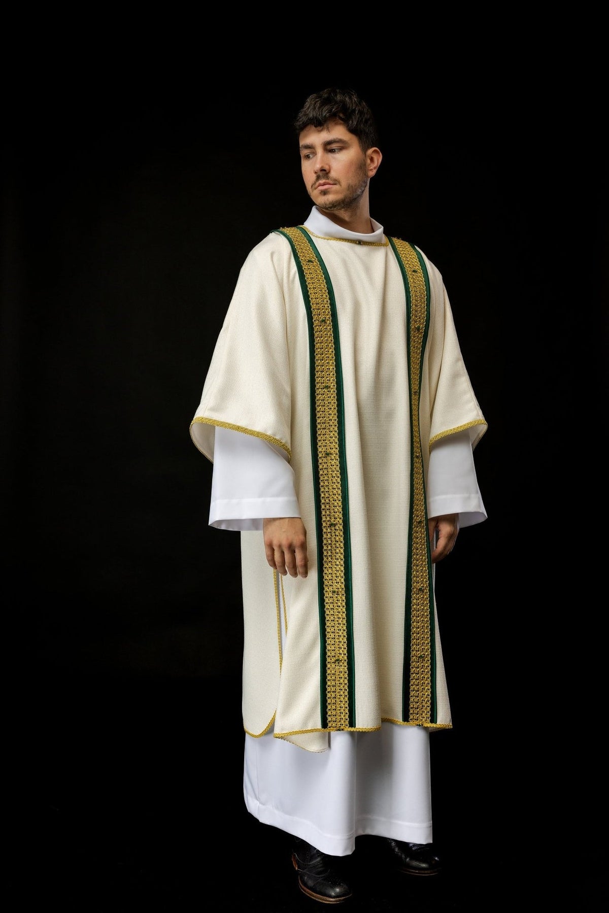 Handcrafted dalmatic worn angled front view with ivory fabric and green and gold orphrey