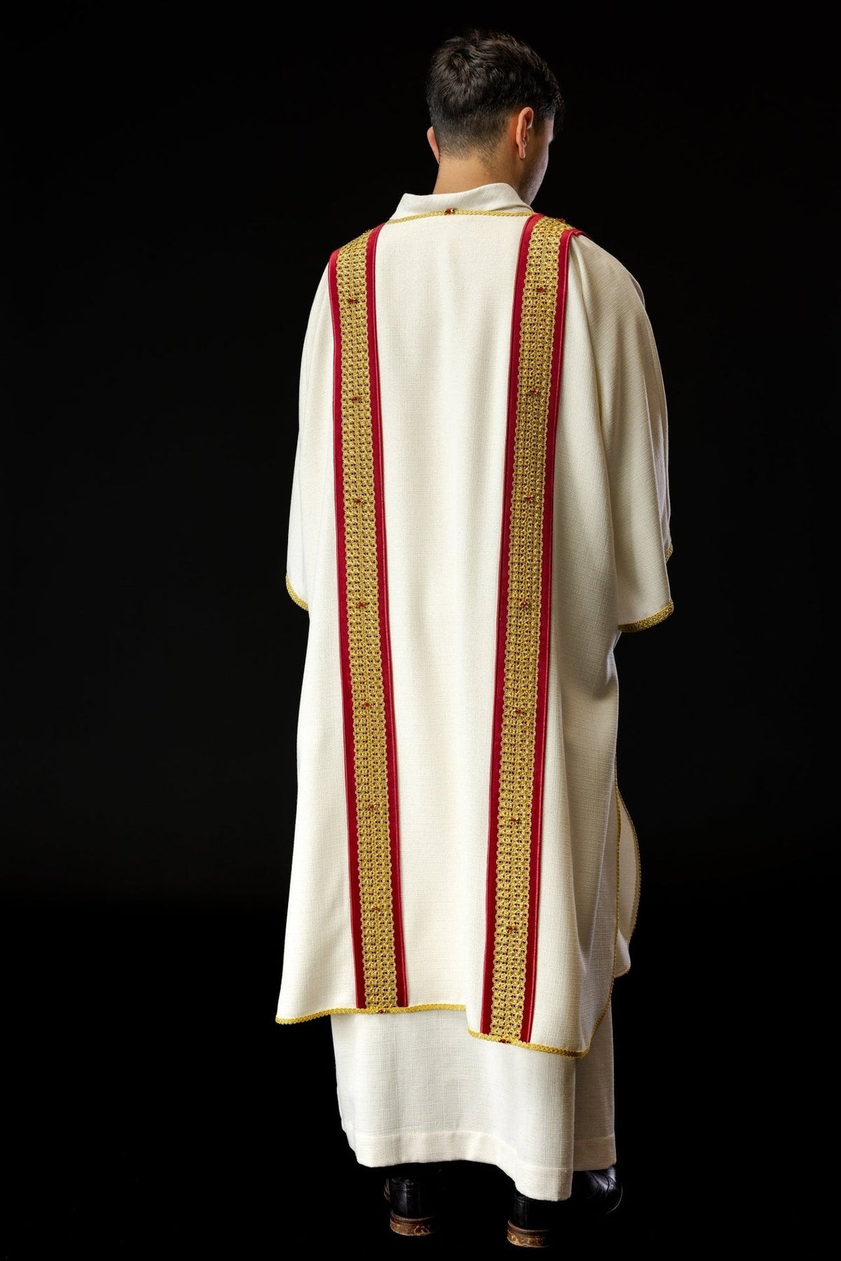 Dalmatic side close-up showing red orphrey, gold embroidery and natural stones