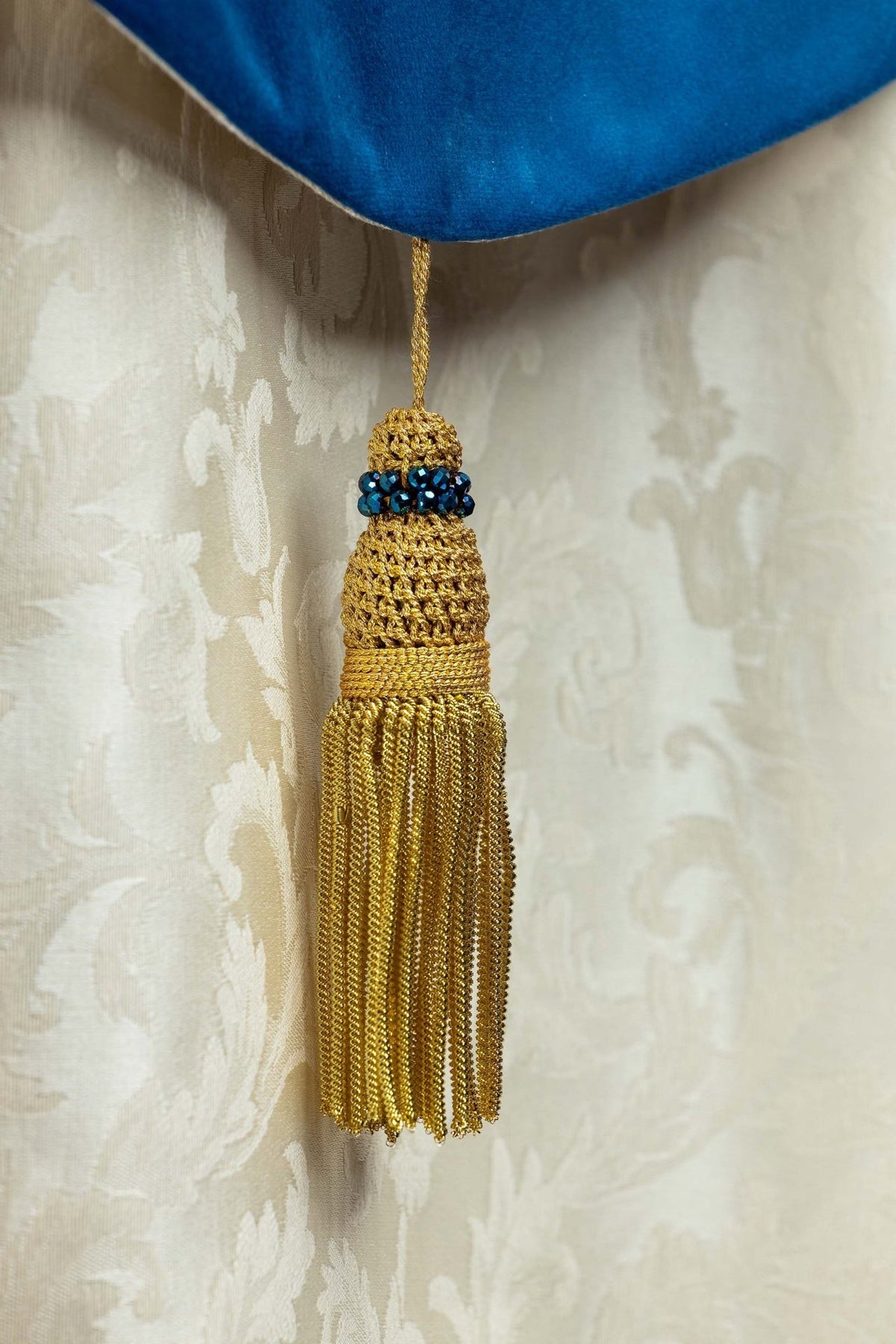 Marian cope tassel close-up with blue natural stones and gold threads