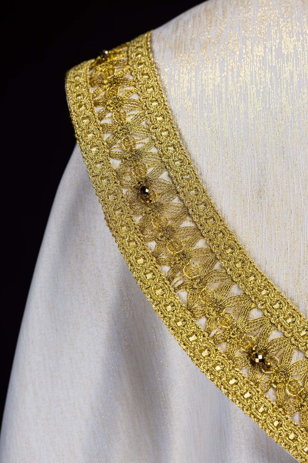 Handcrafted cope gold embroidered side trim with natural stones, close-up