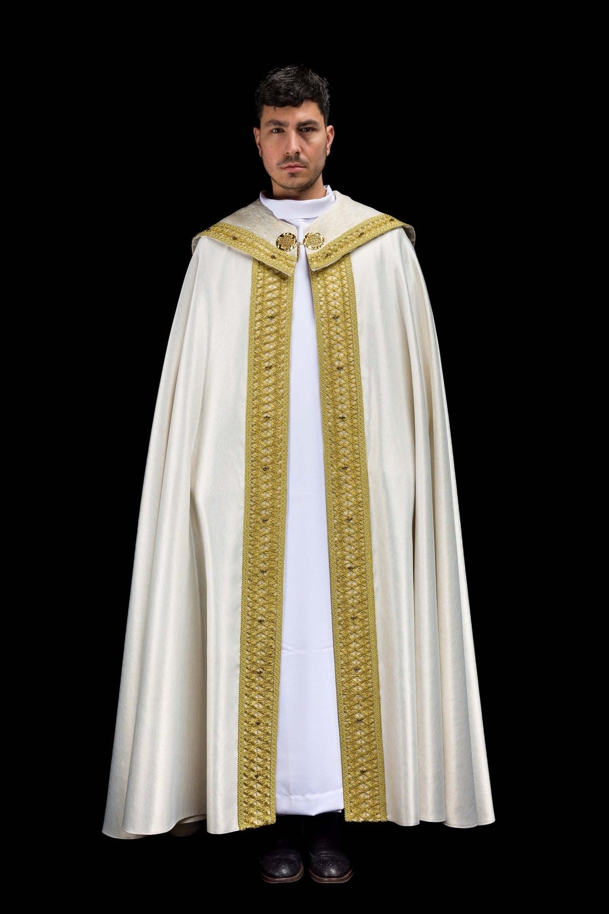Handcrafted cope in ecru with gold embroidered trim, front view