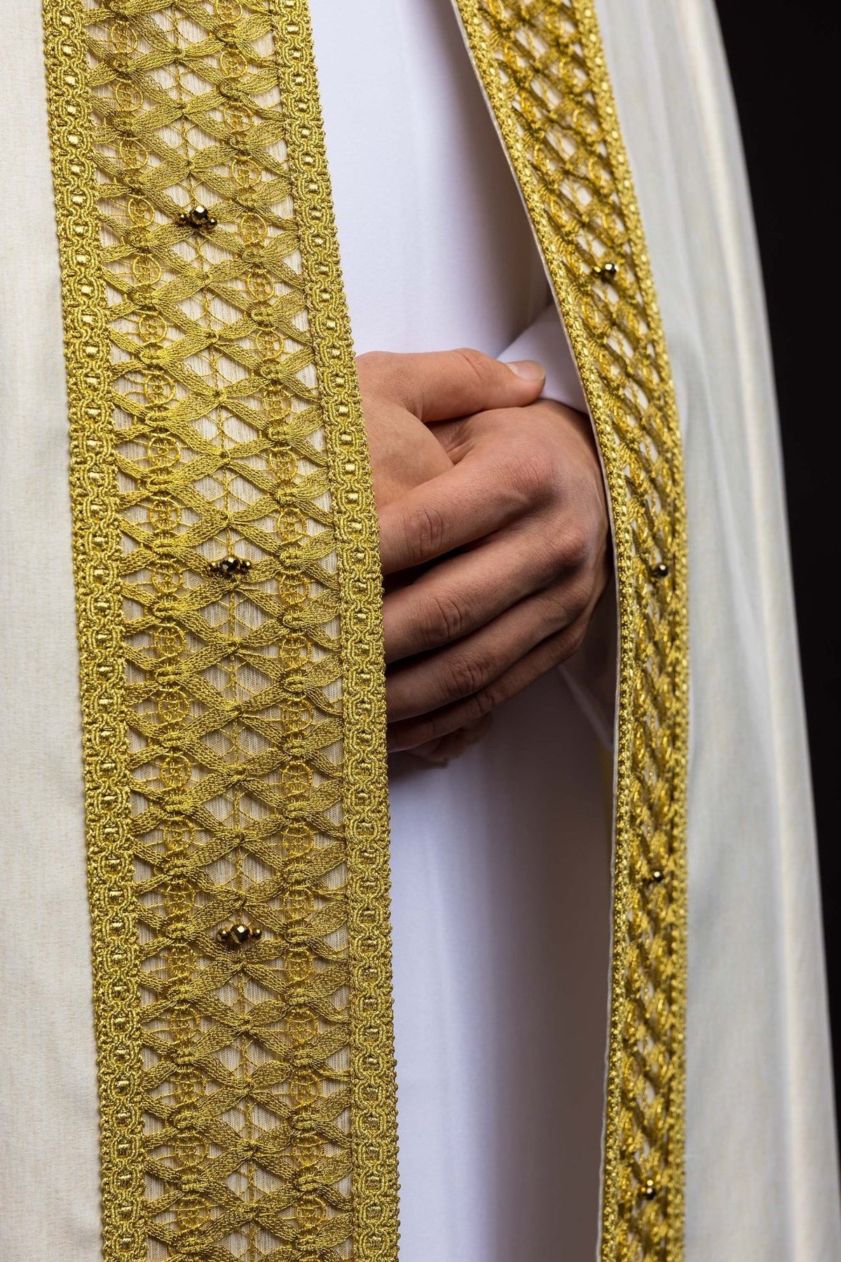 Handcrafted cope gold embroidered front trim with natural stones, close-up