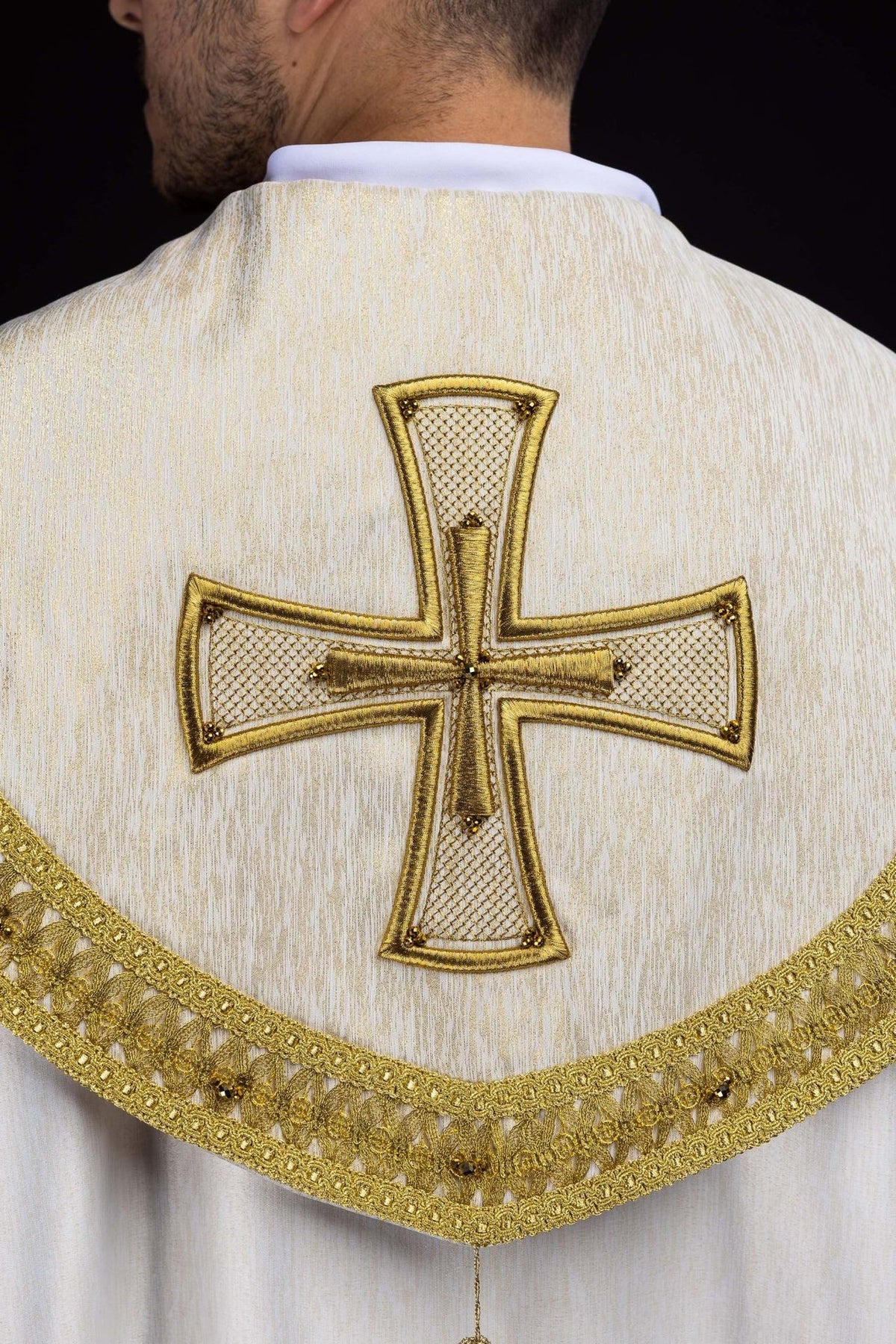 Handcrafted cope gold lattice embroidery with natural stones, close-up