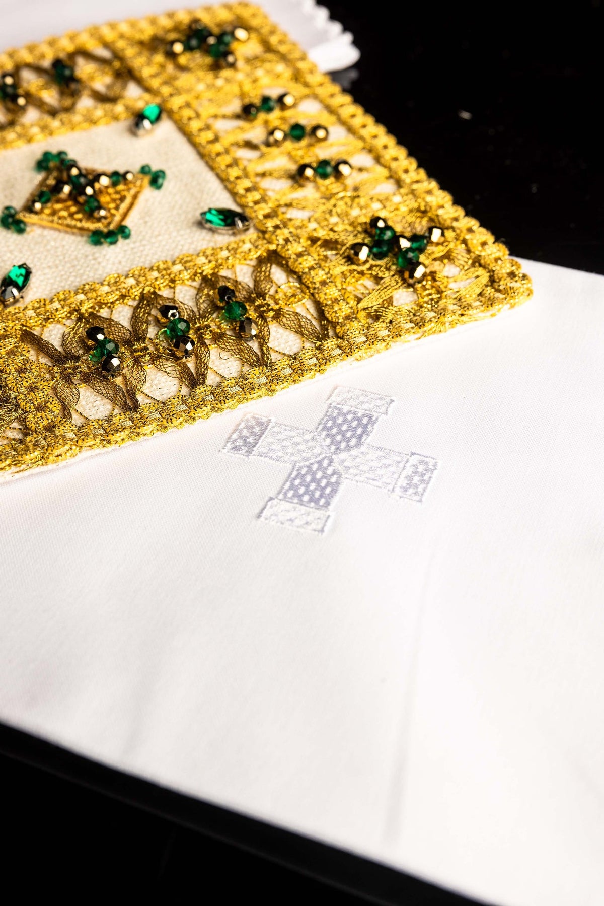 Altar linen set angled detail of gold leaf-pattern embroidery and faceted green stones