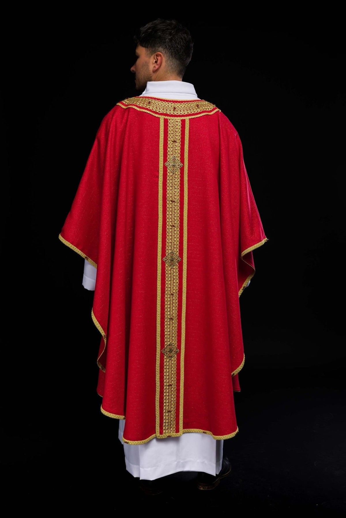 Handcrafted chasuble worn, back view with red fabric and gold orphrey embroidery