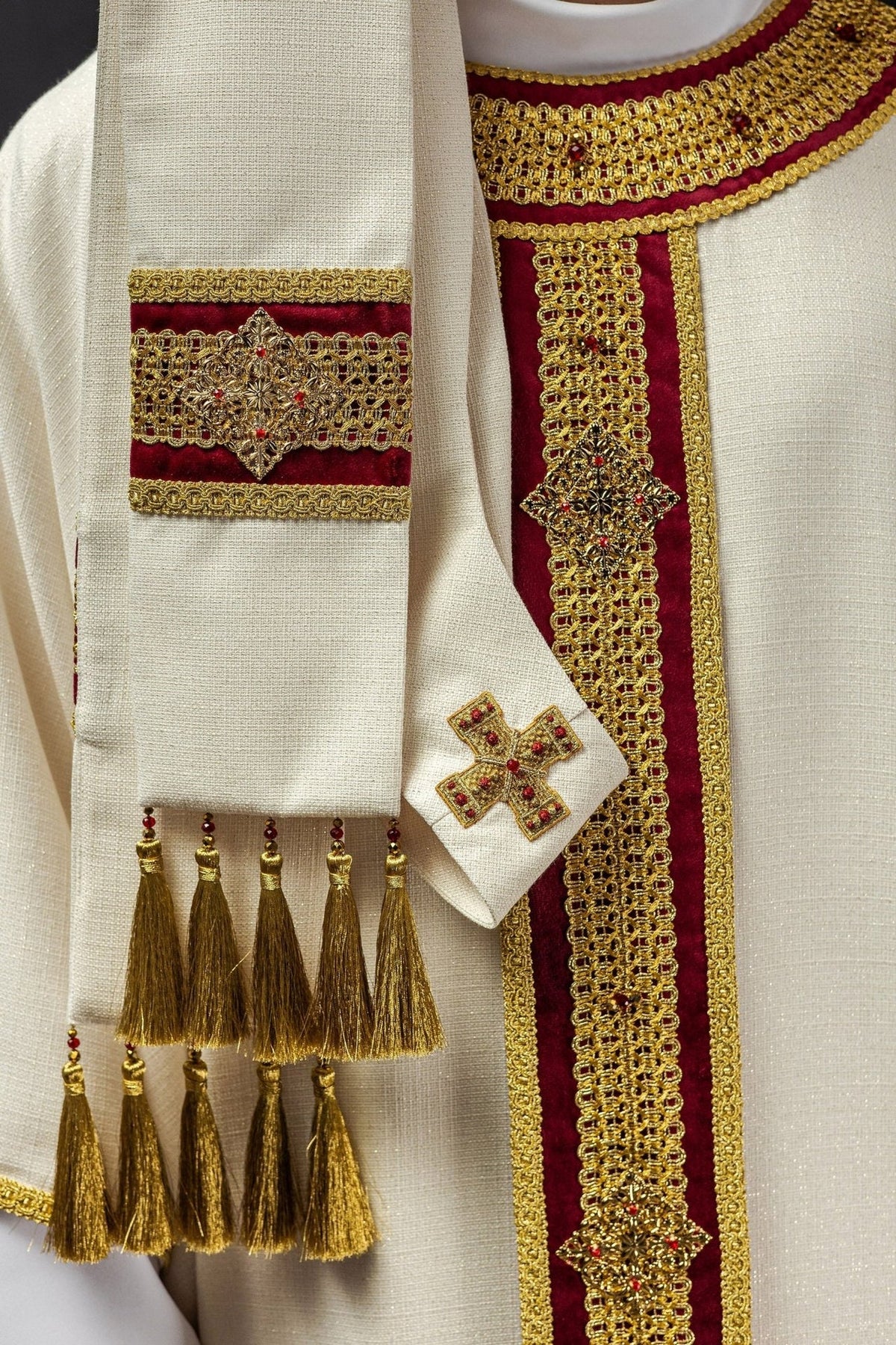 Stole detail with gold embroidery, red velvet panels, cross motif and gold tassel