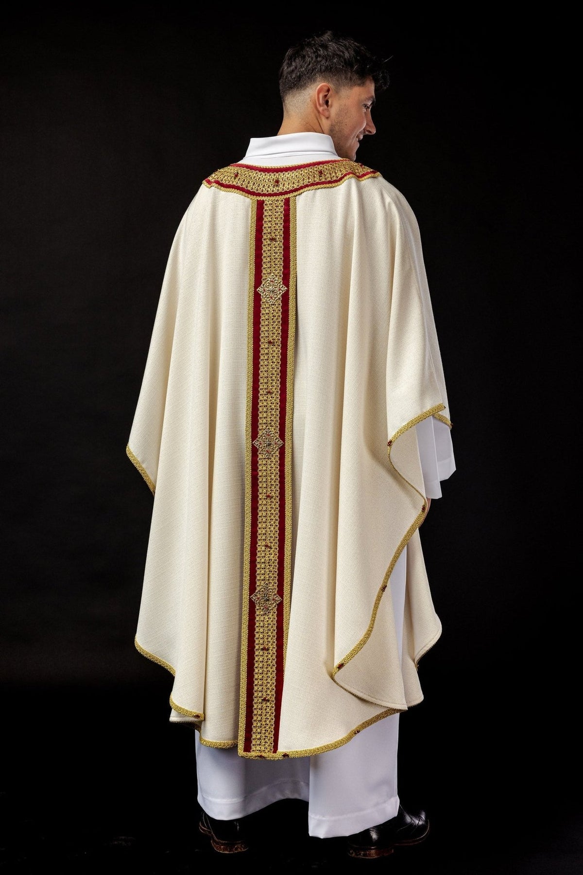 Back view of the ivory chasuble with red and gold central orphrey