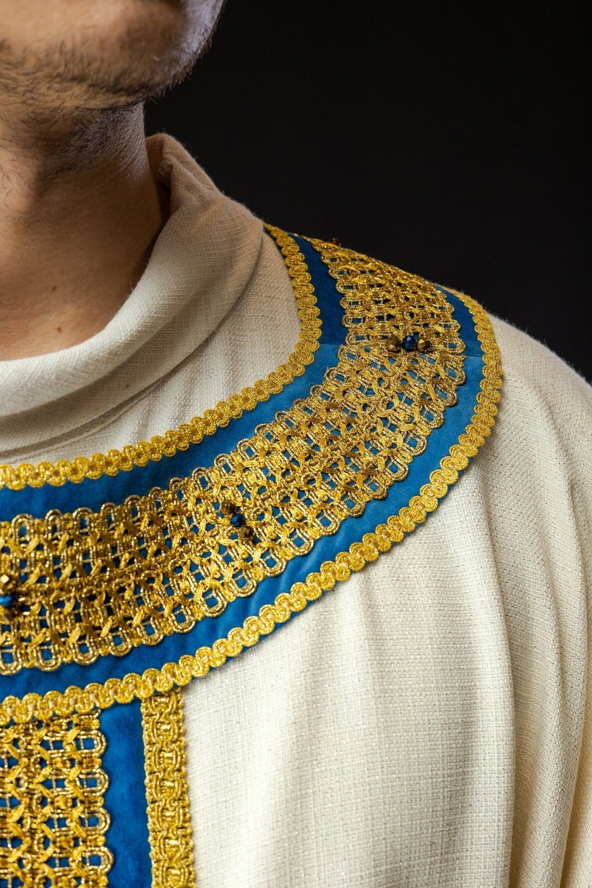 Handcrafted chasuble close-up of blue and gold collar embroidery with natural stones
